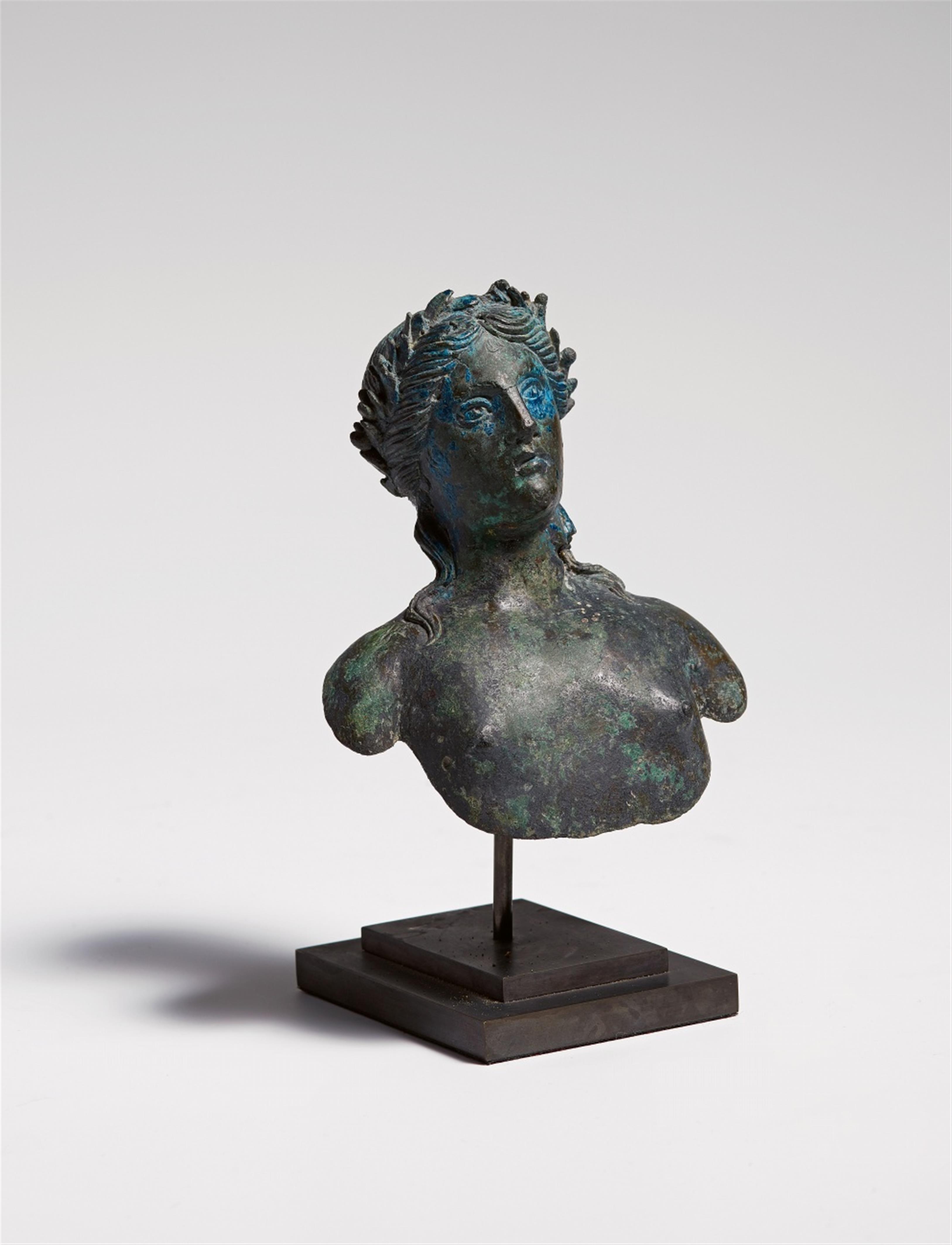 A cast bronze phalera with a bust of Apollo - image-1
