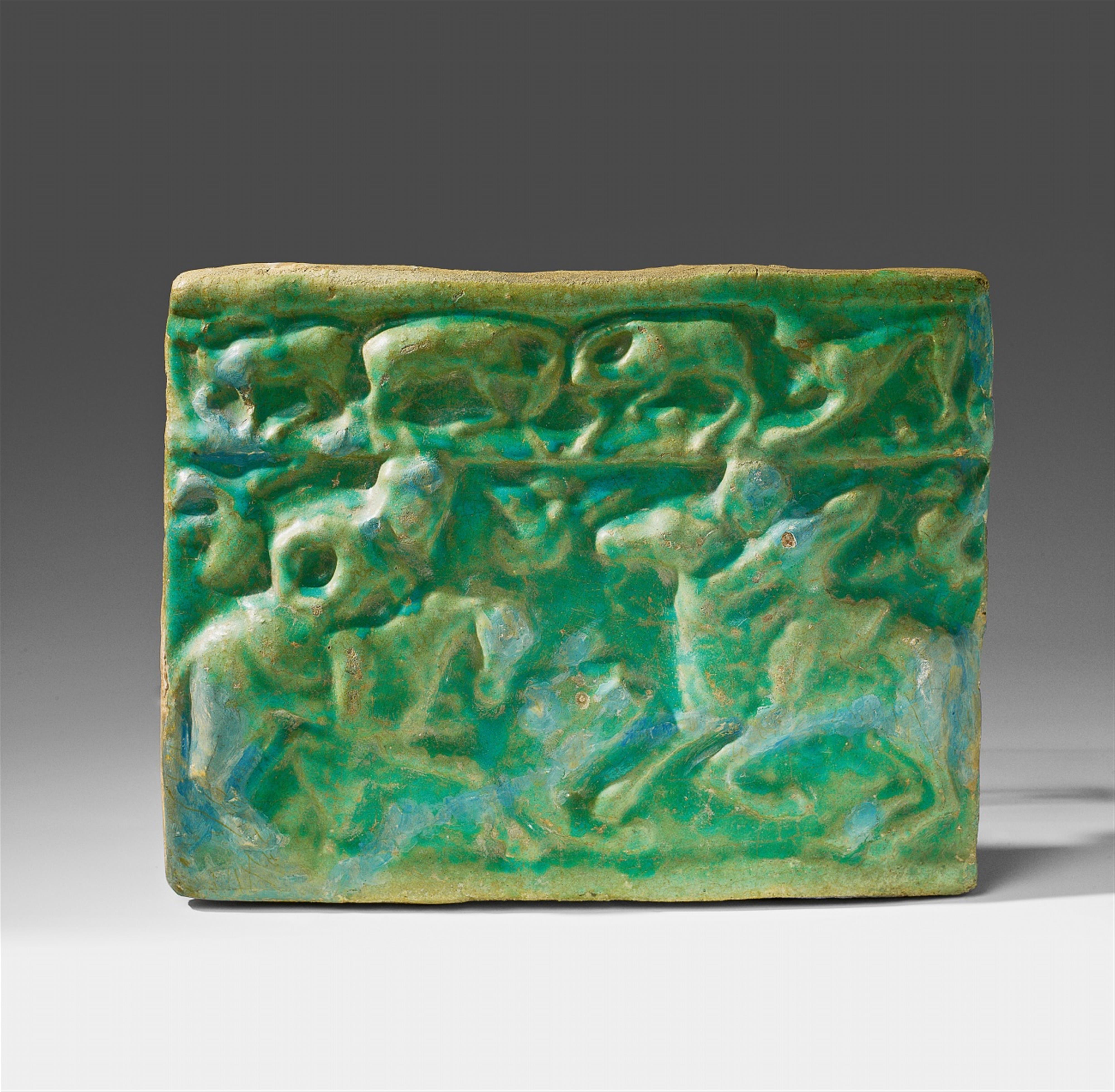 An Iranian fritware tile with a hunting scene - image-1