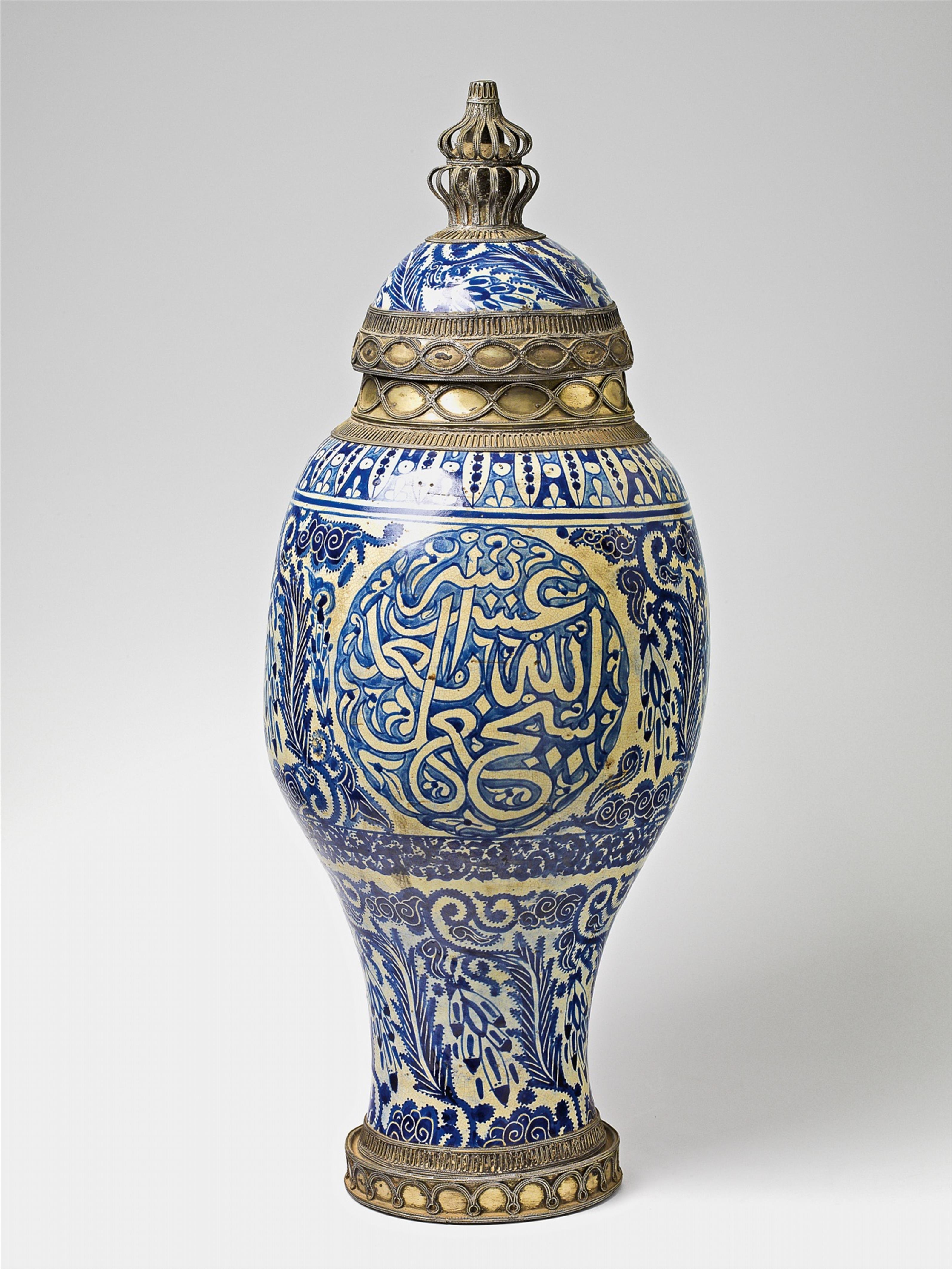 A Moroccan metal-mounted ceramic storage jar - image-1