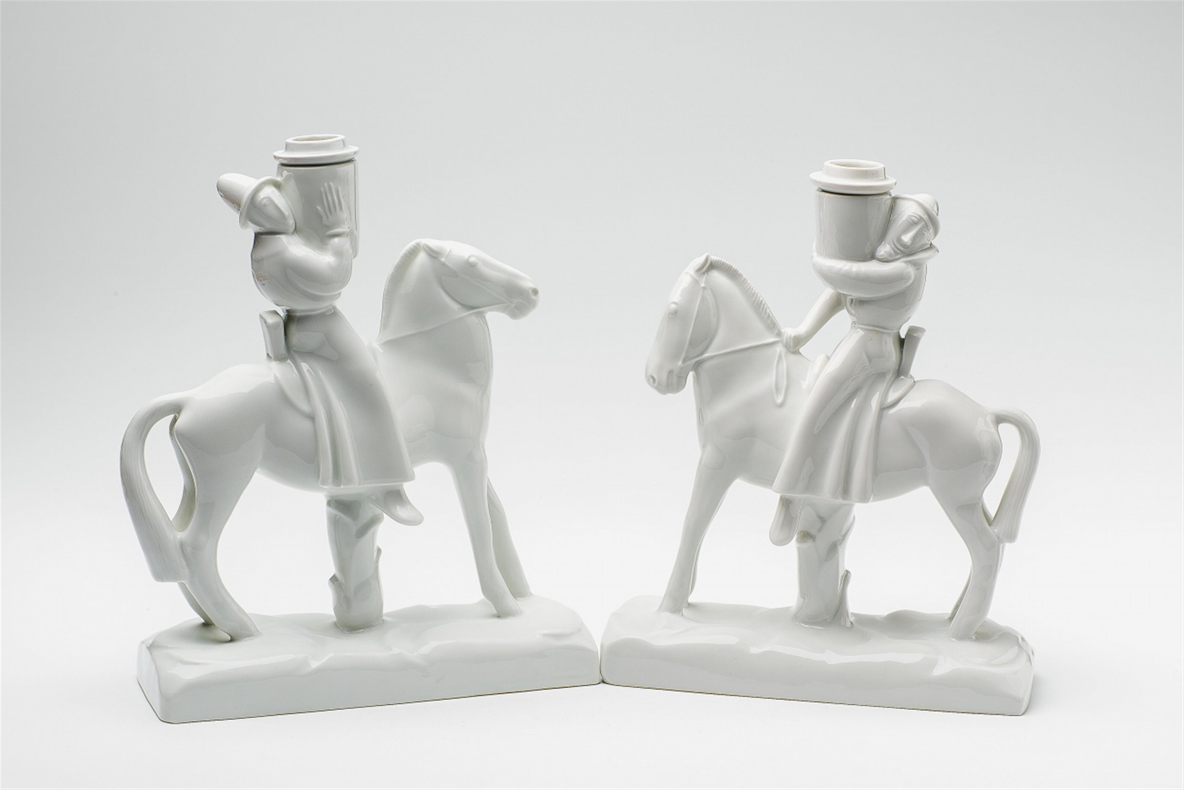 A pair of facing white porcelain candlesticks formed as horsemen - image-1
