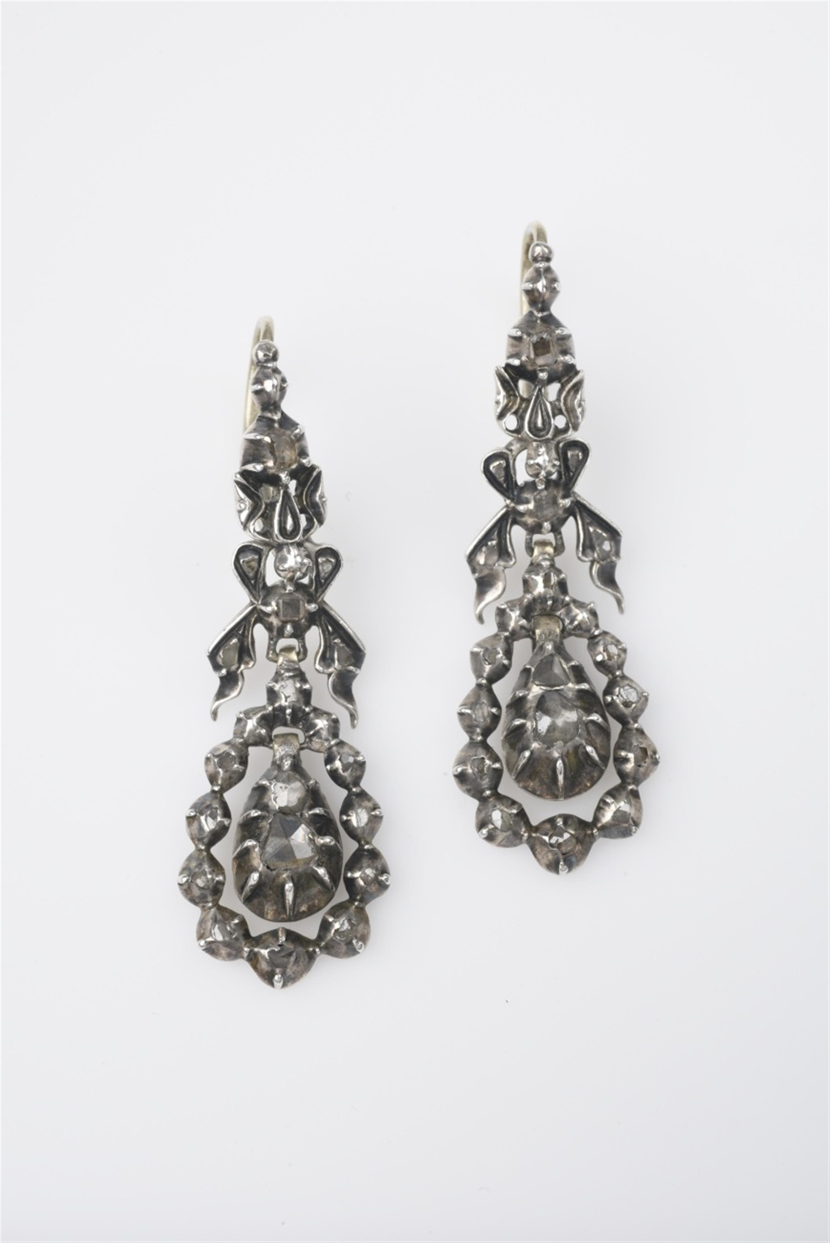 A pair of silver and diamond pendant earrings - image-1