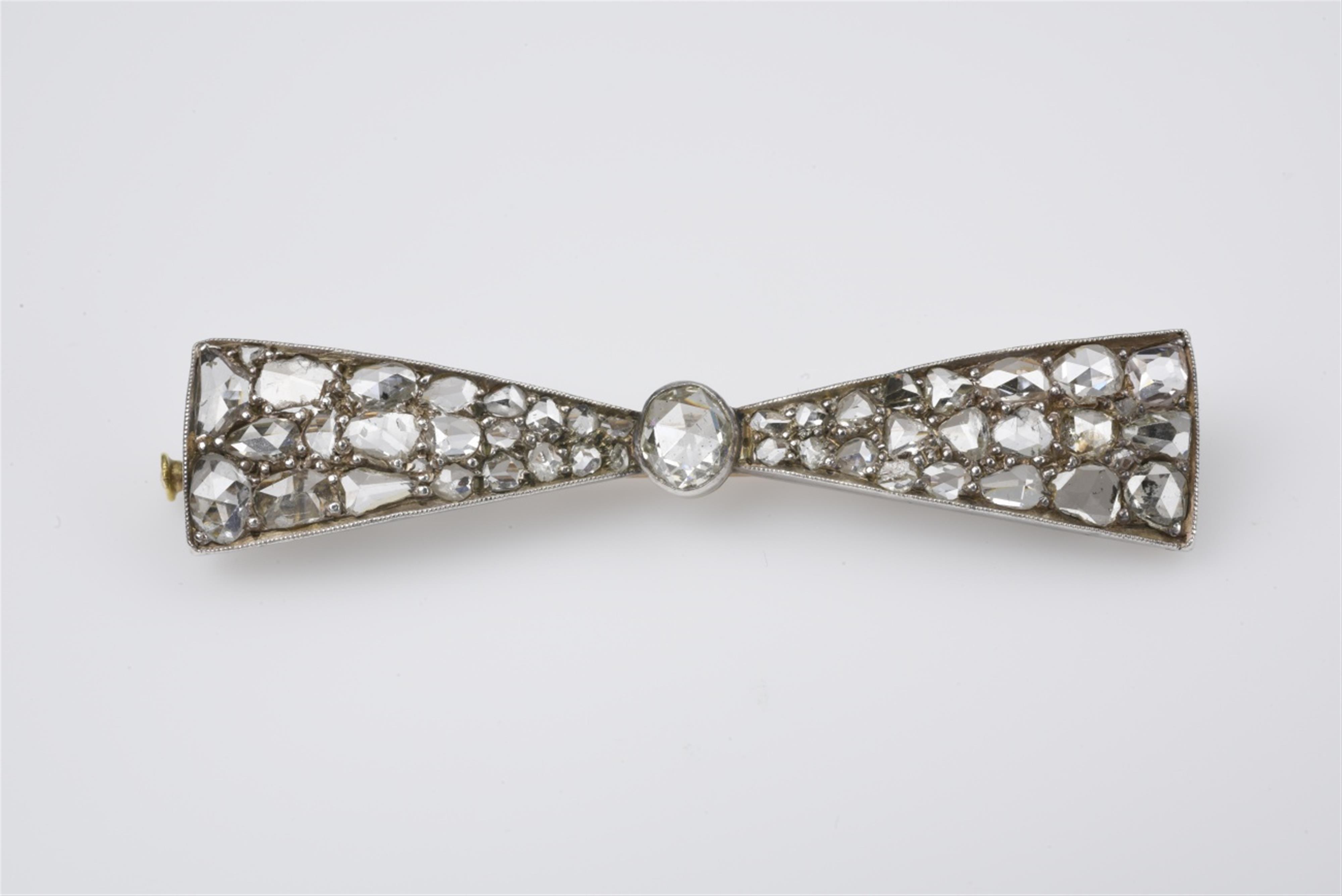 A 14k gold, silver, and diamond bow brooch - image-1