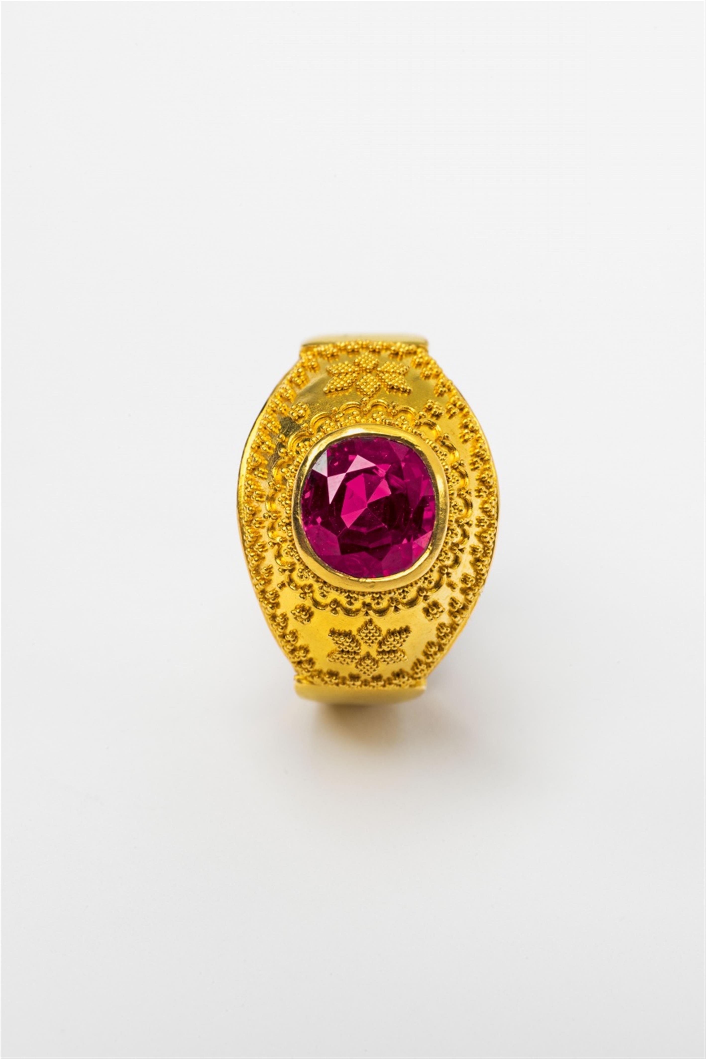 An 18/21k gold and pink sapphire ring by Hans Schott - image-3