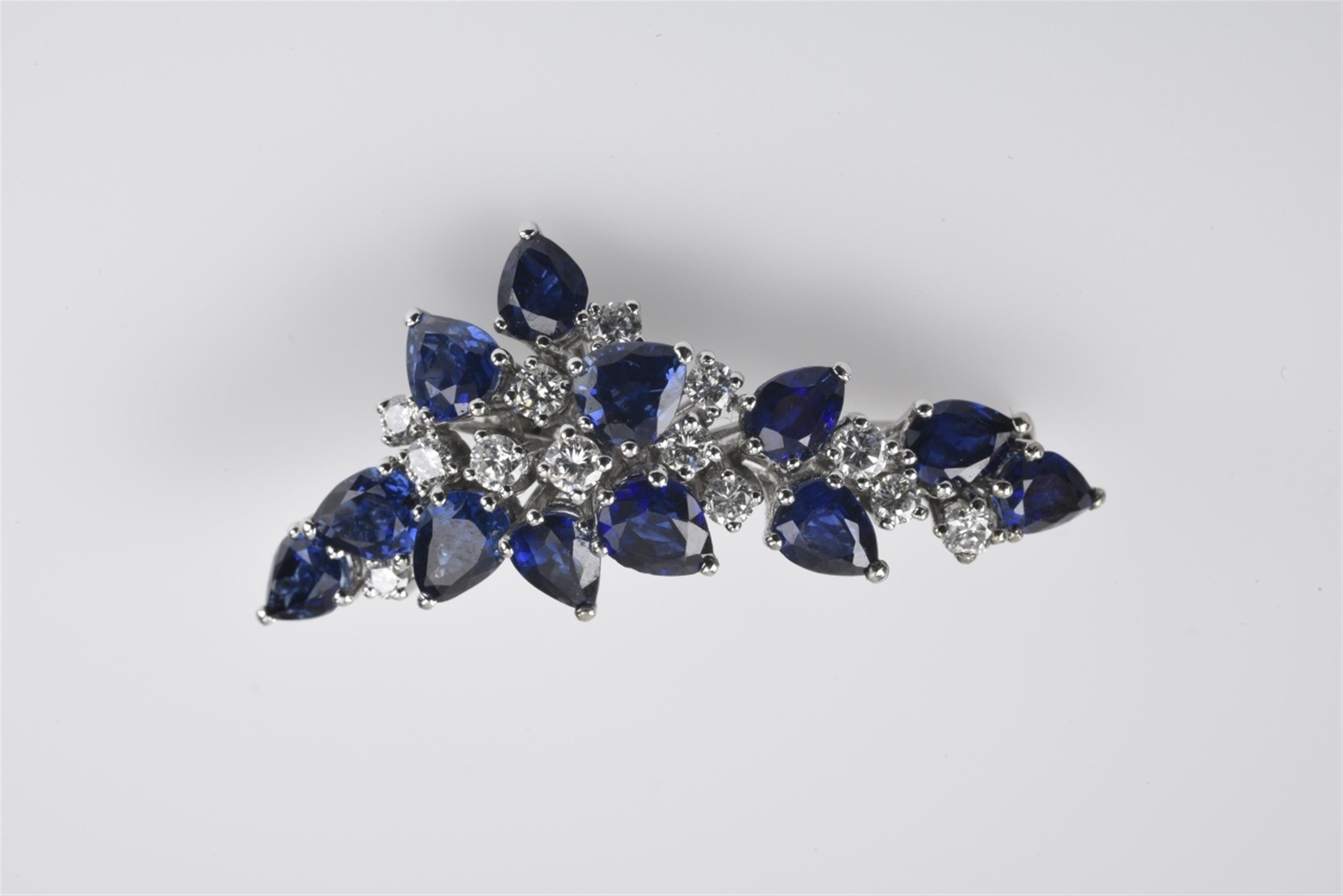 A small 18k white gold and sapphire brooch - image-1