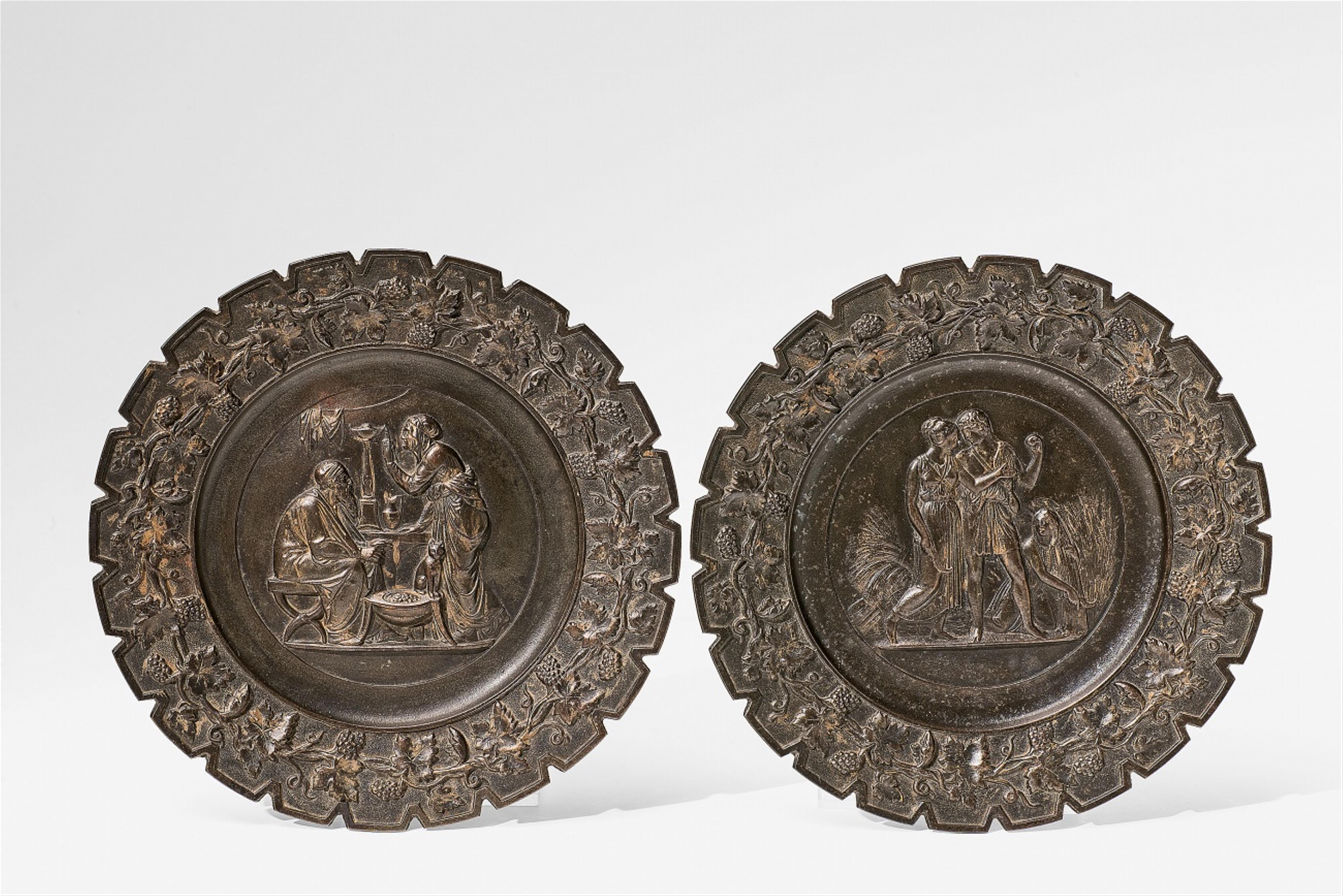 A pair of cast iron plates with seasonal allegories - image-1