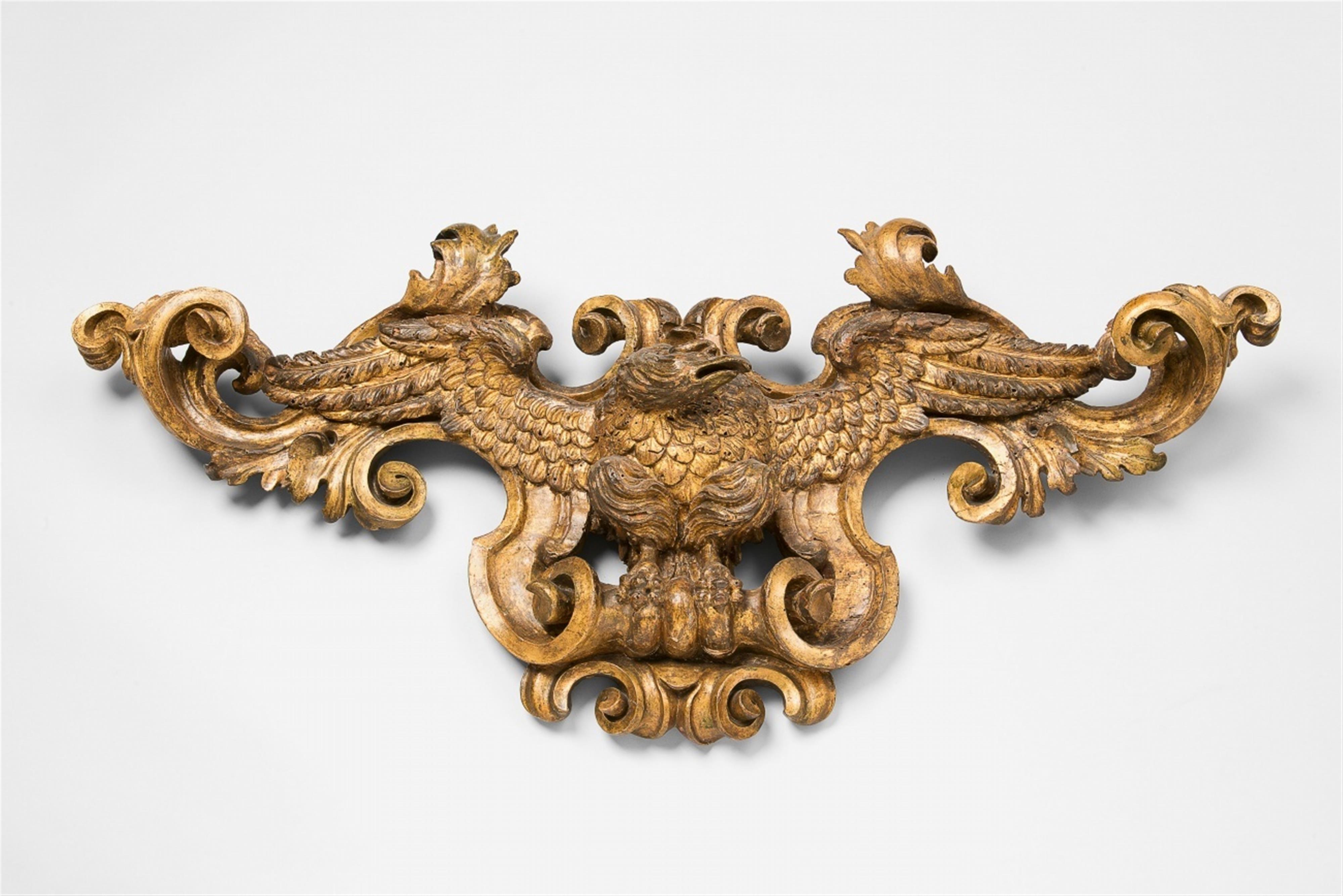 A carved giltwood cartouche with an eagle in flight - image-1