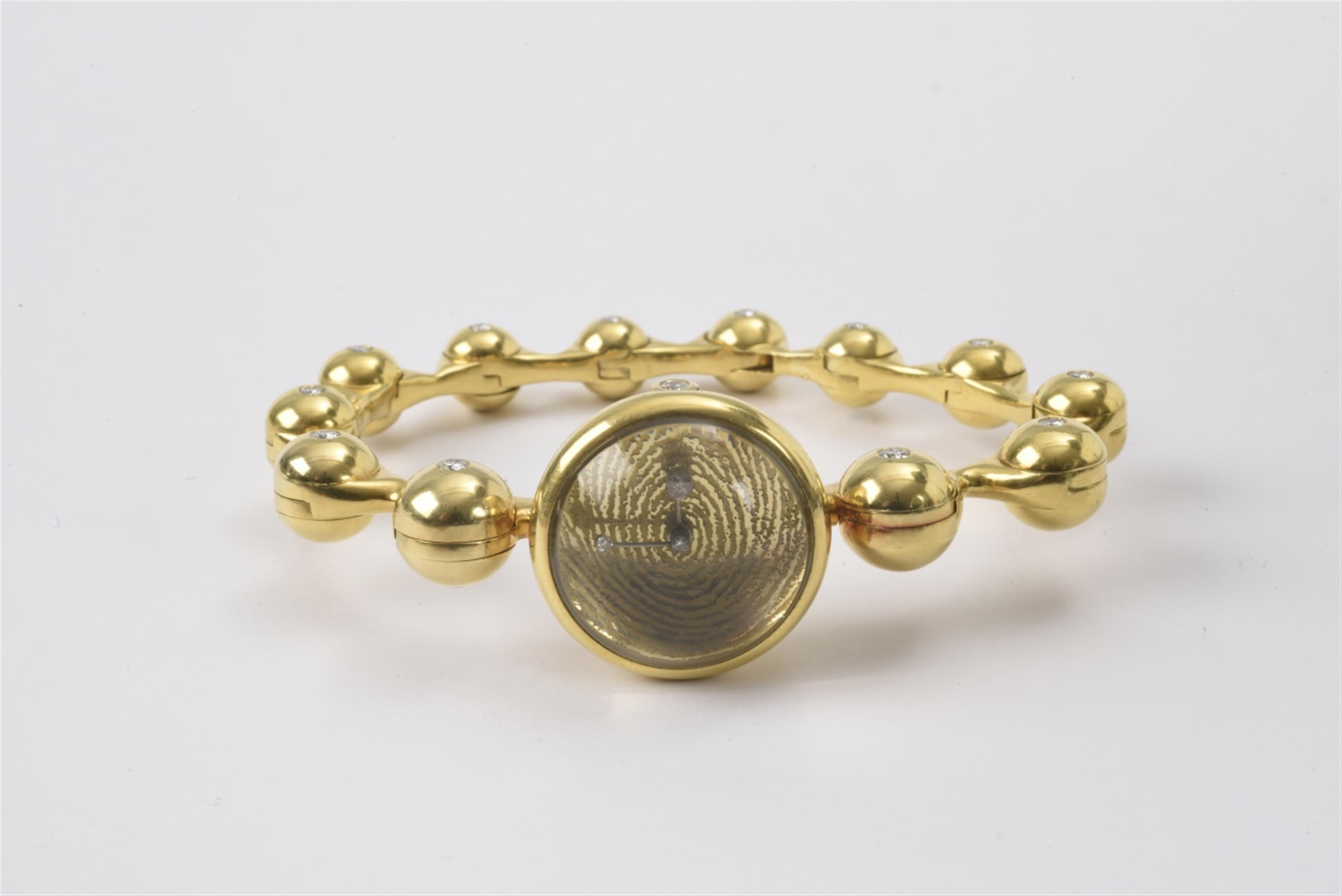 An 18k gold bracelet with a watch - image-1