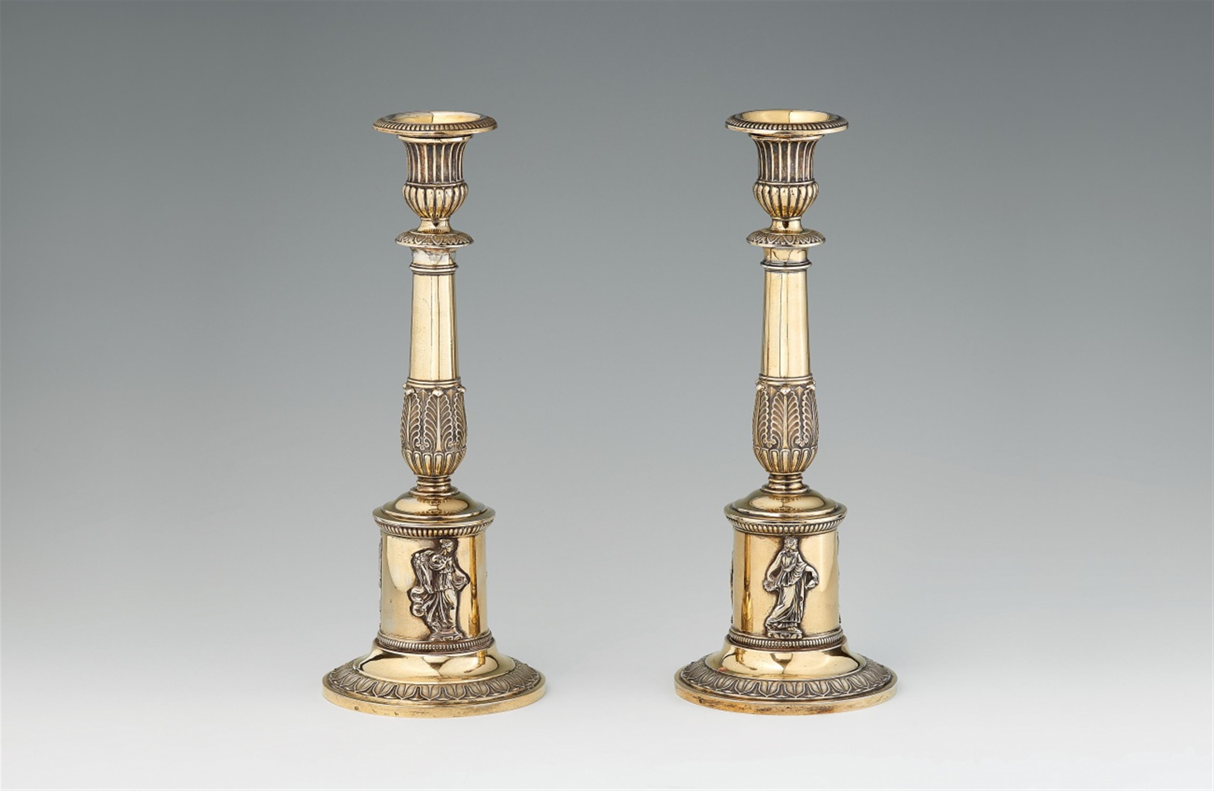 A pair of Neoclassical silver gilt candlesticks - image-1