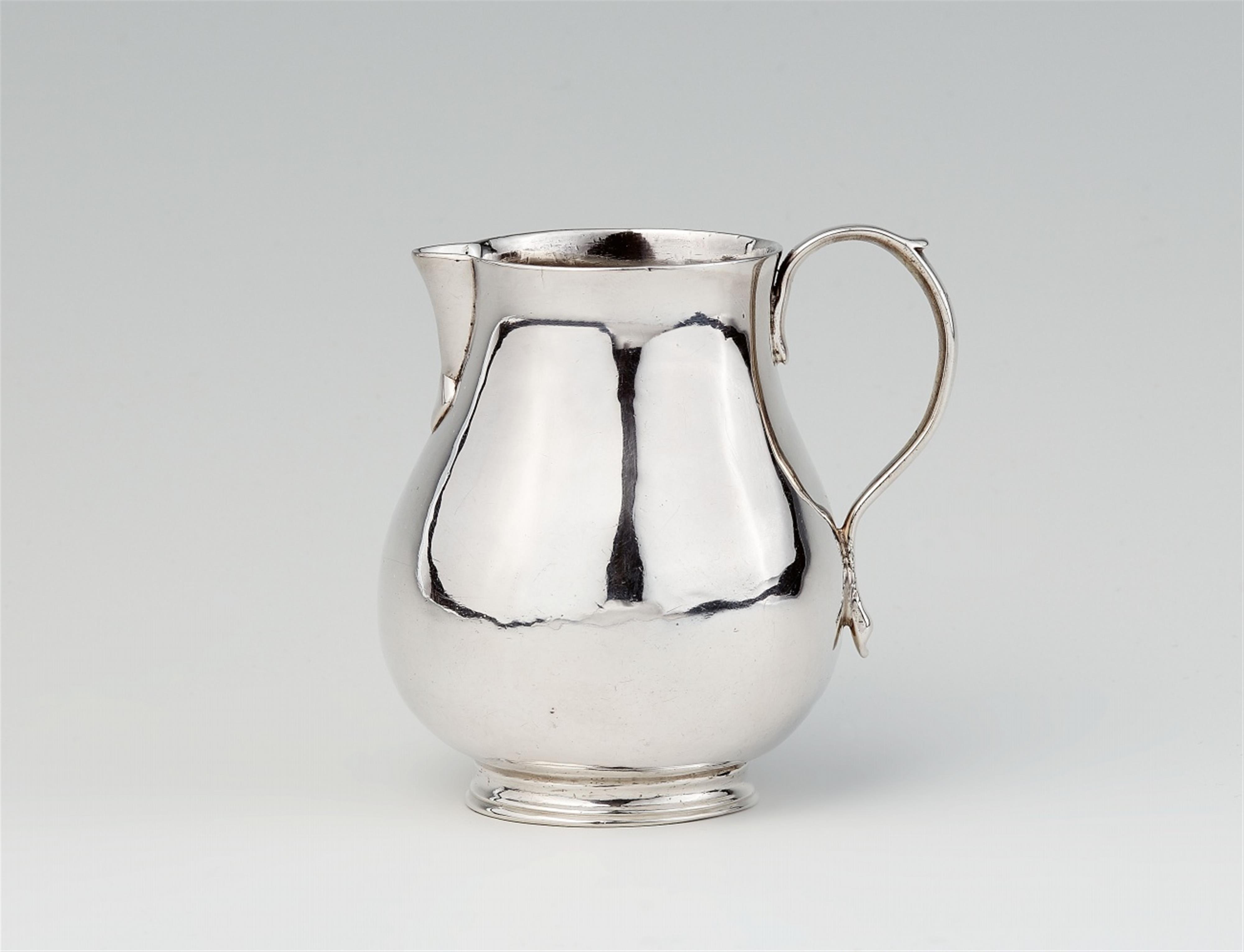 A George II silver cream jug - image-1