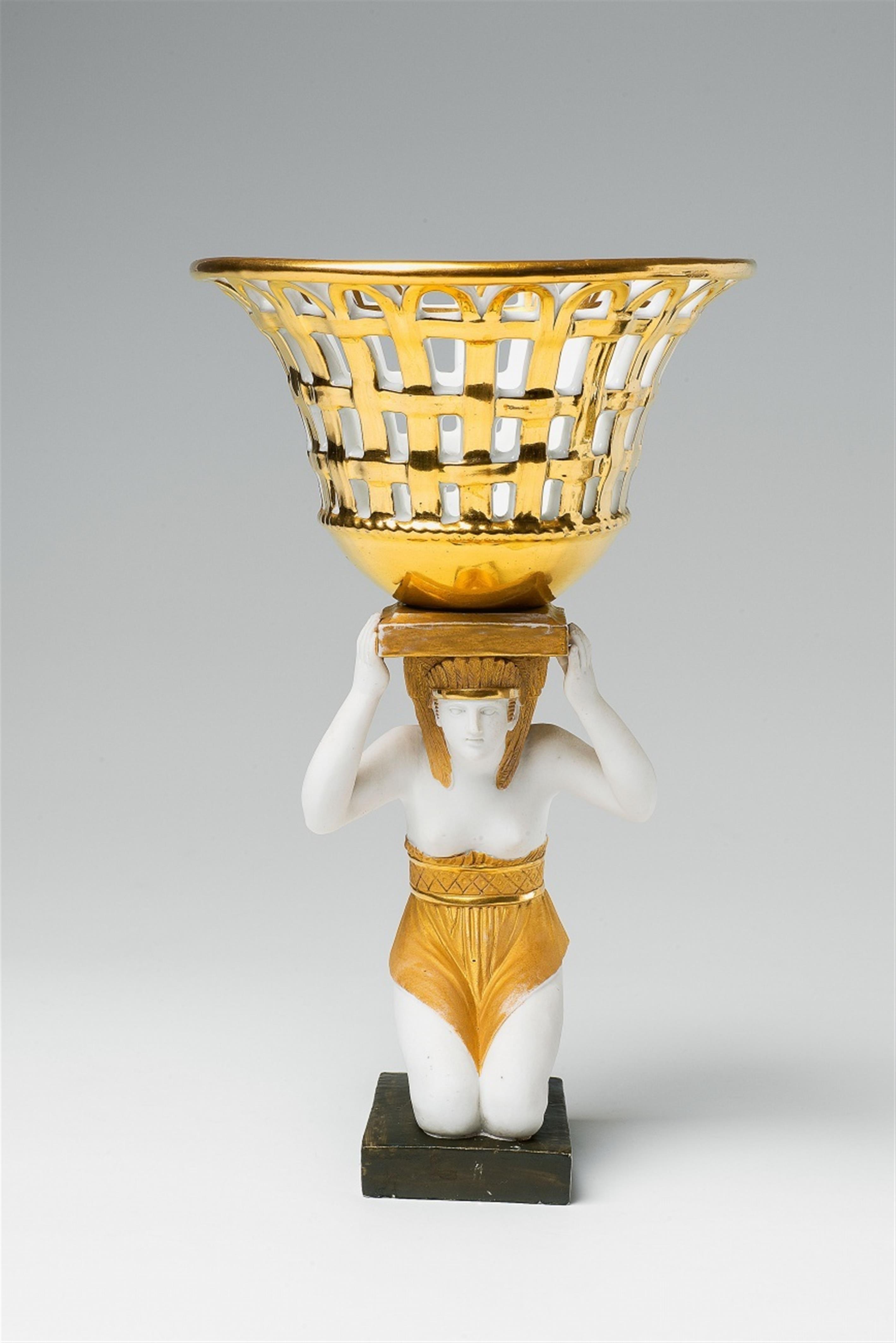 A Parisian porcelain figure of an Egyptian carrying a basket - image-1