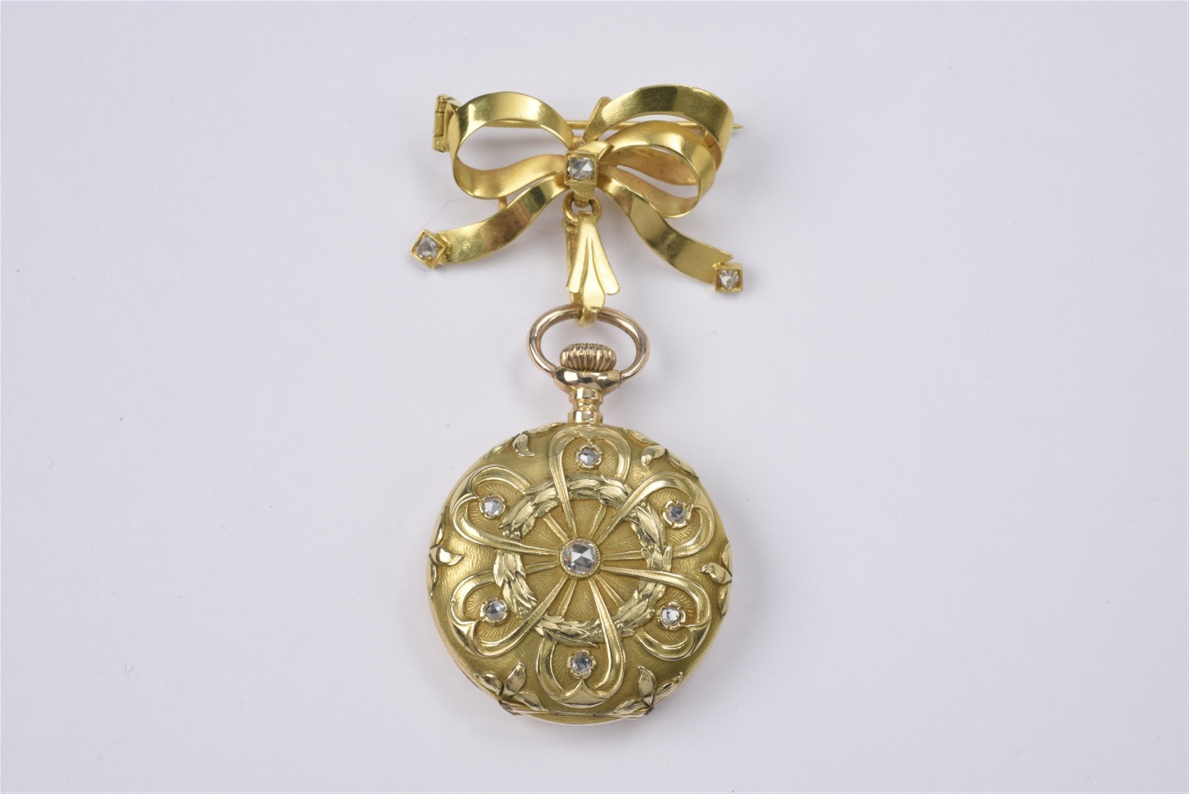 An 18k gold bow brooch with a watch pendant - image-1