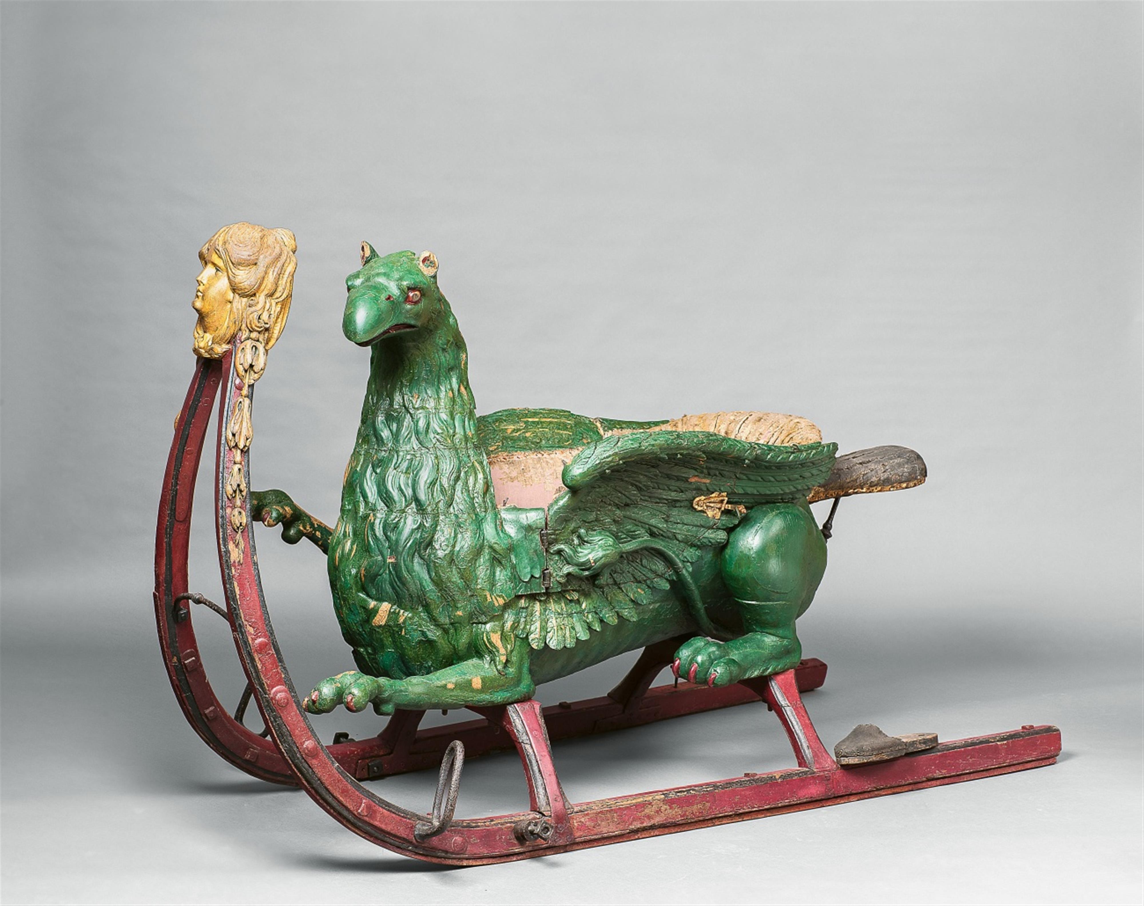 A large carved wooden sleigh formed as a griffon - image-1