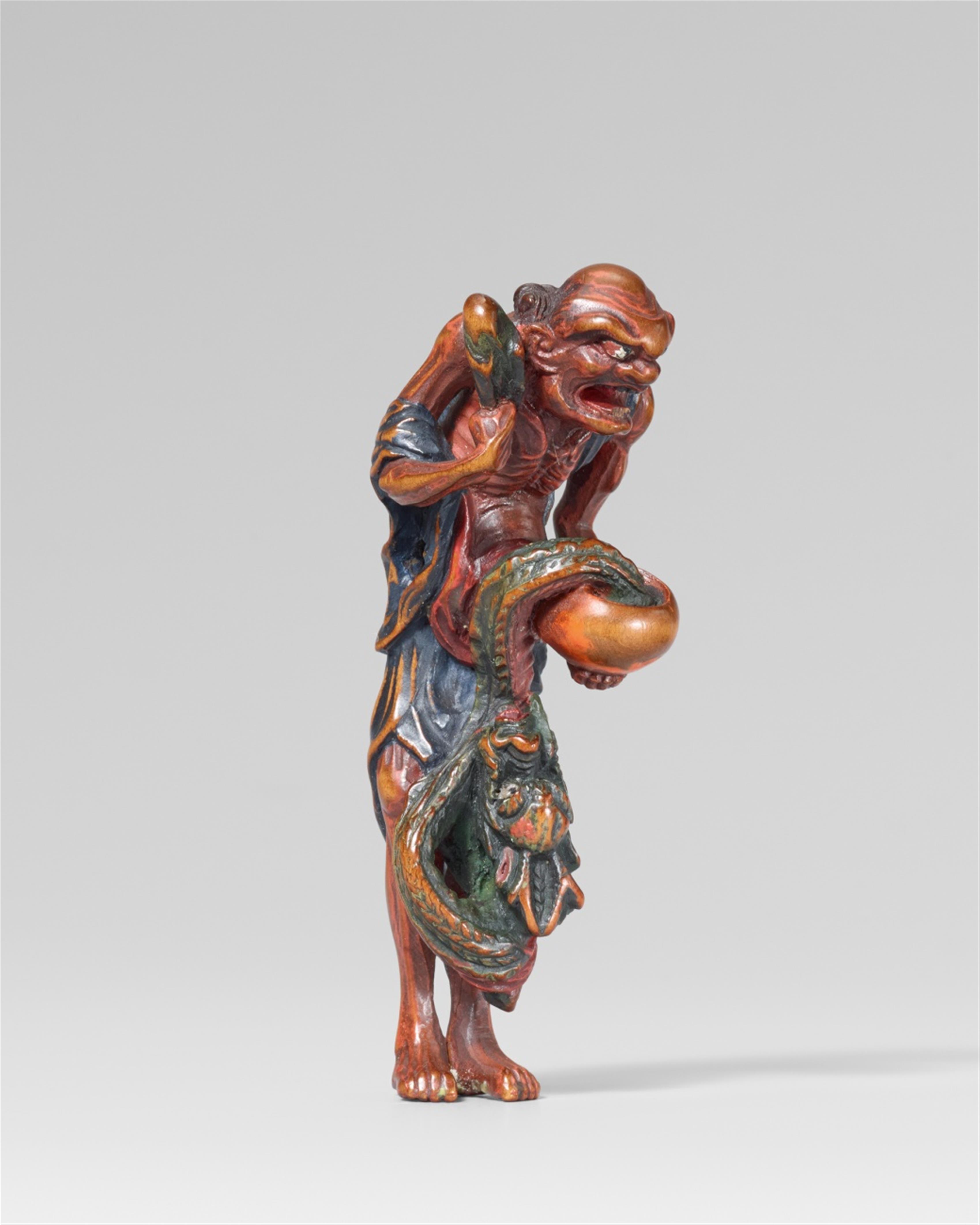 A painted wood netsuke of a rakan with a dragon. 19th century - image-1