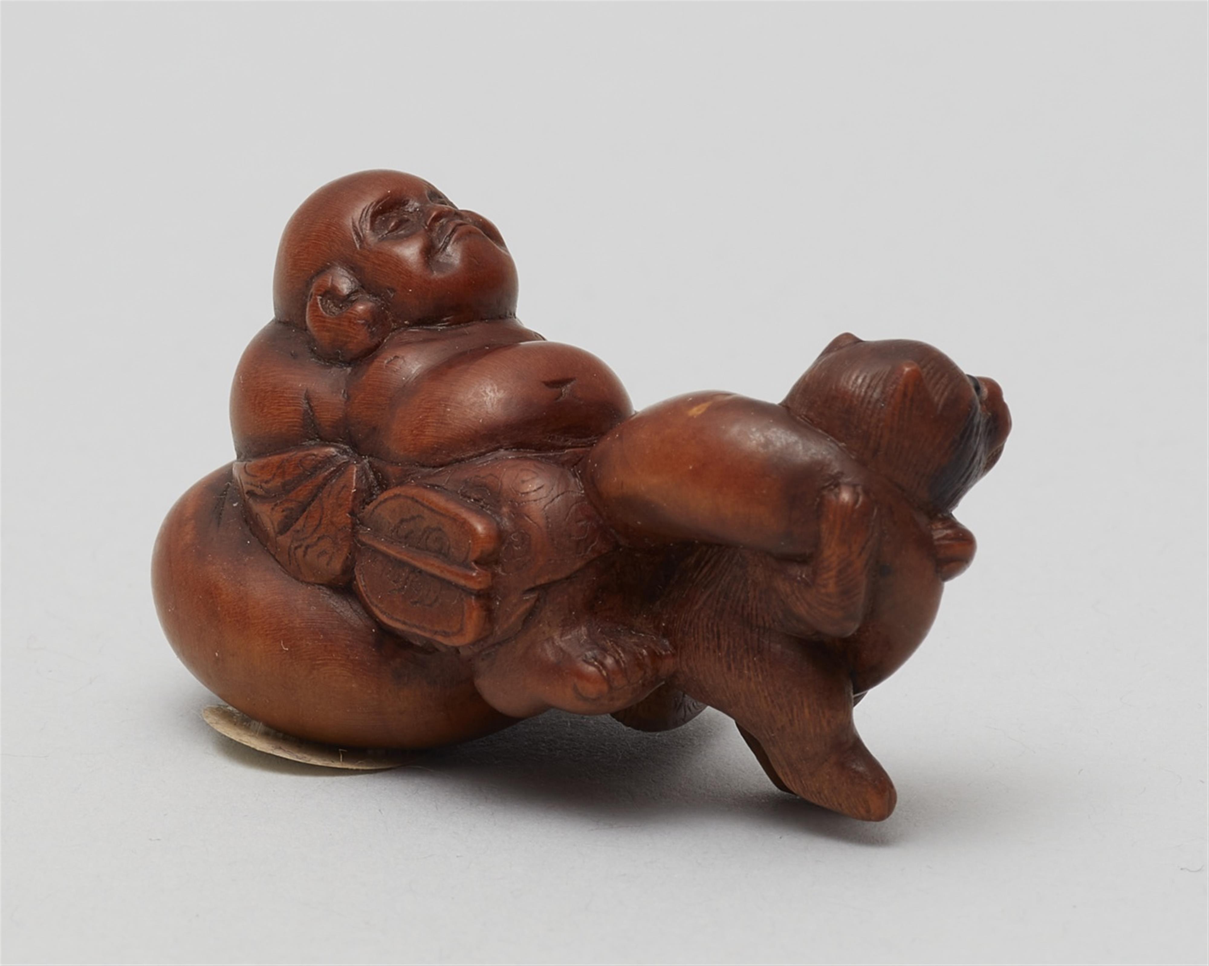 A boxwood netsuke of Hotei being pulled by a tanuki. 19th century - image-2