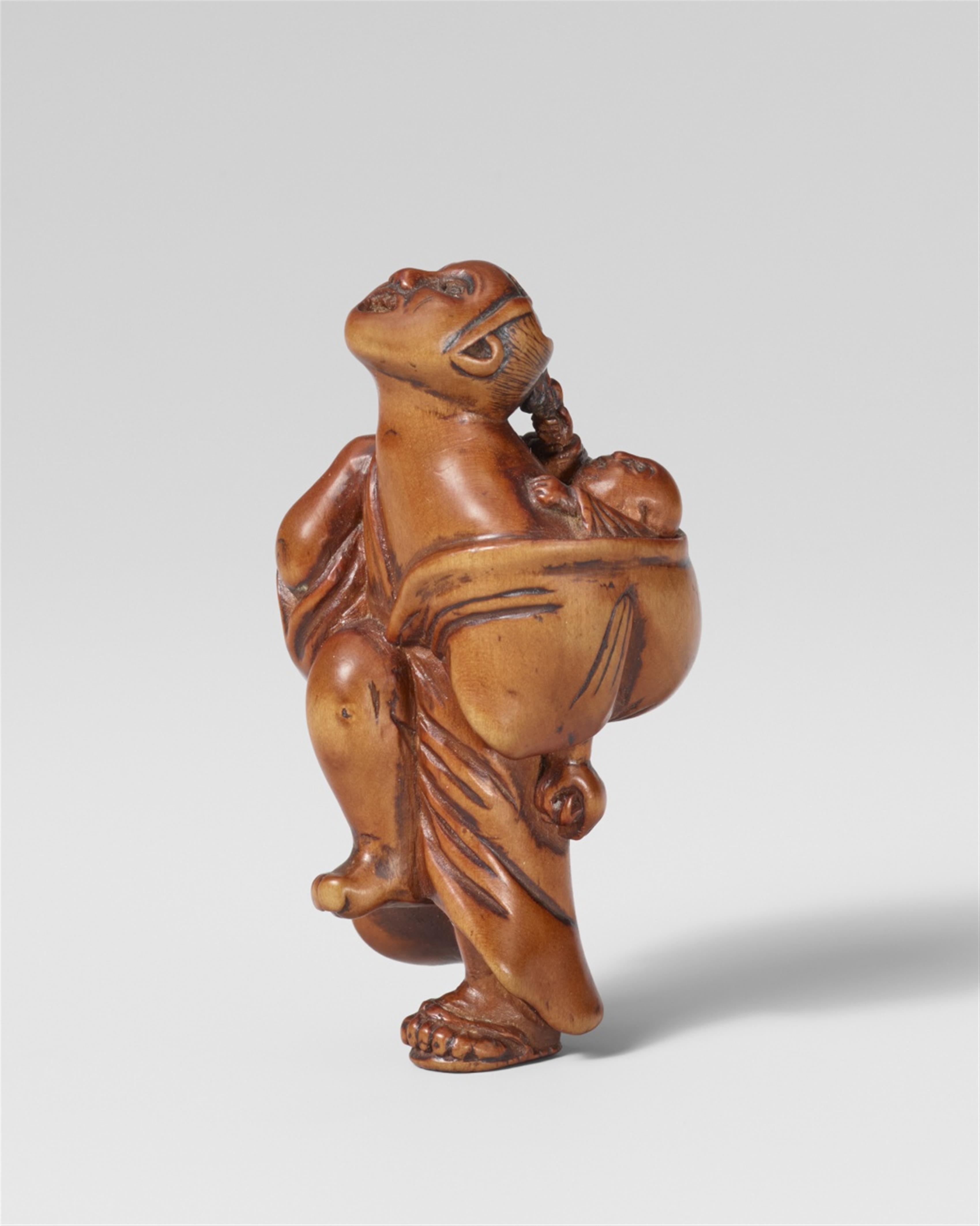 An unusual boxwood netsuke of a figure with a child. Early 19th century - image-1