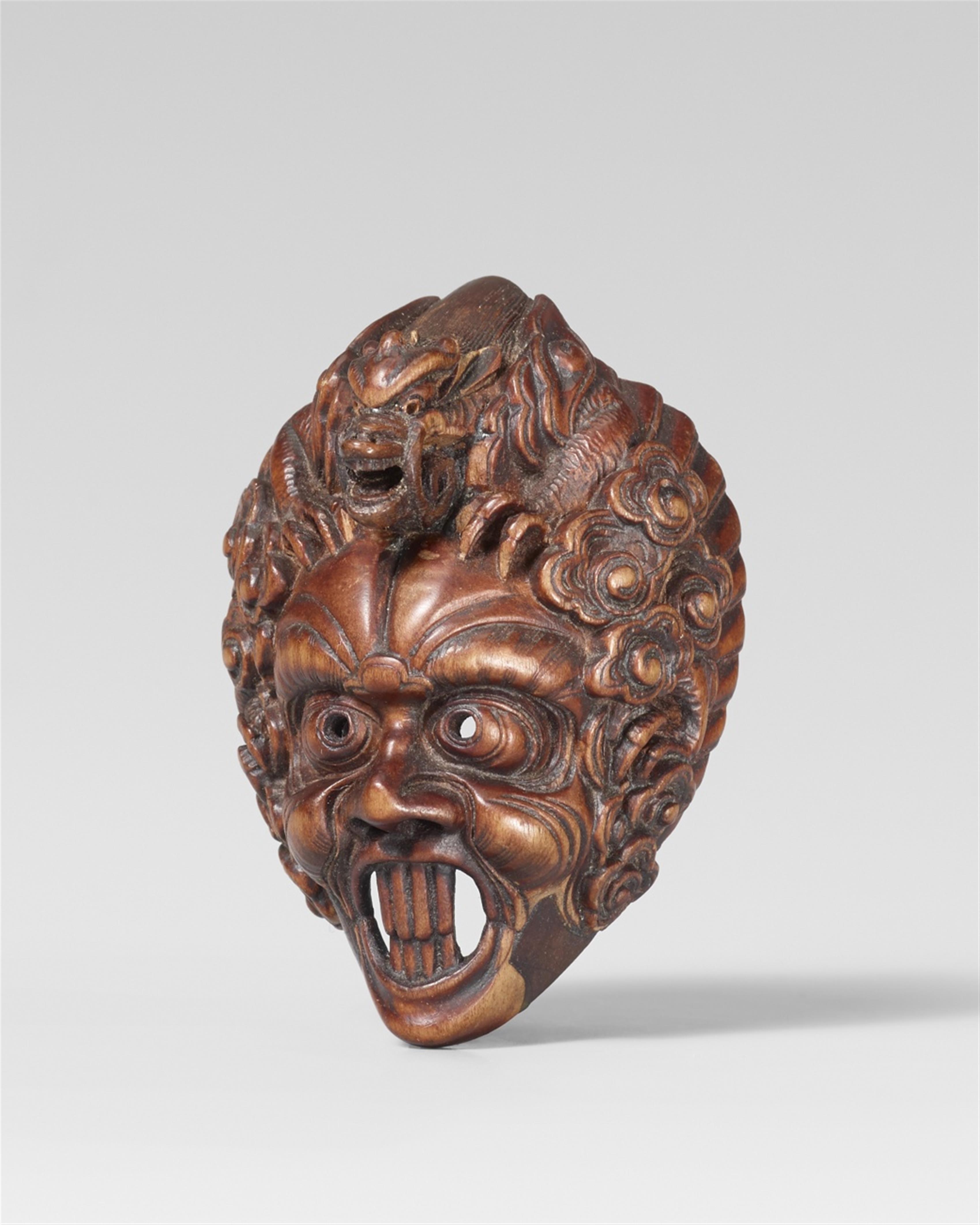 A fine boxwood netsuke of a Ranryôô mask. Late 19th century - image-1