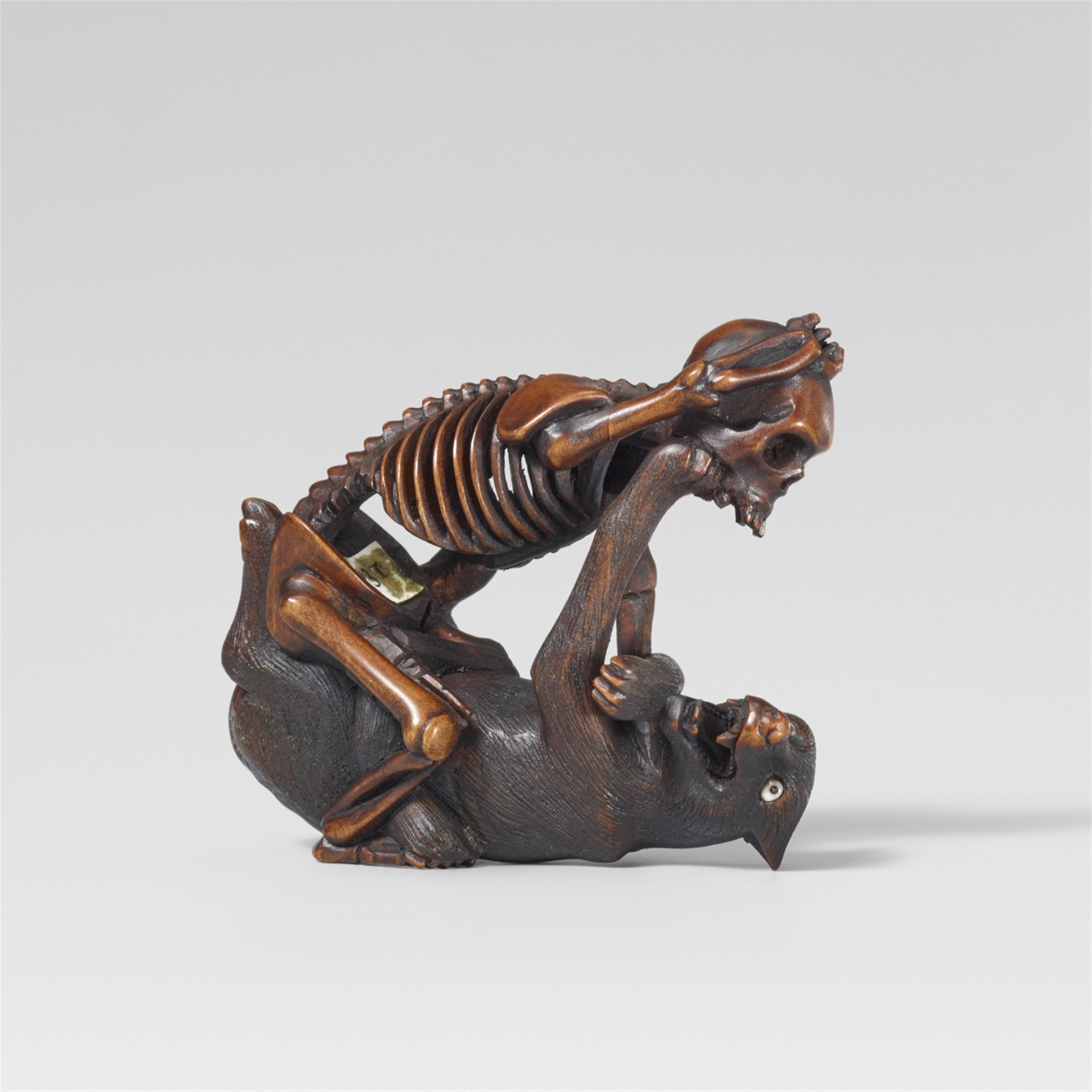 A Hida school boxwood netsuke of a skeleton and a wolf, in the style of Shôko. Late 19th century - image-1