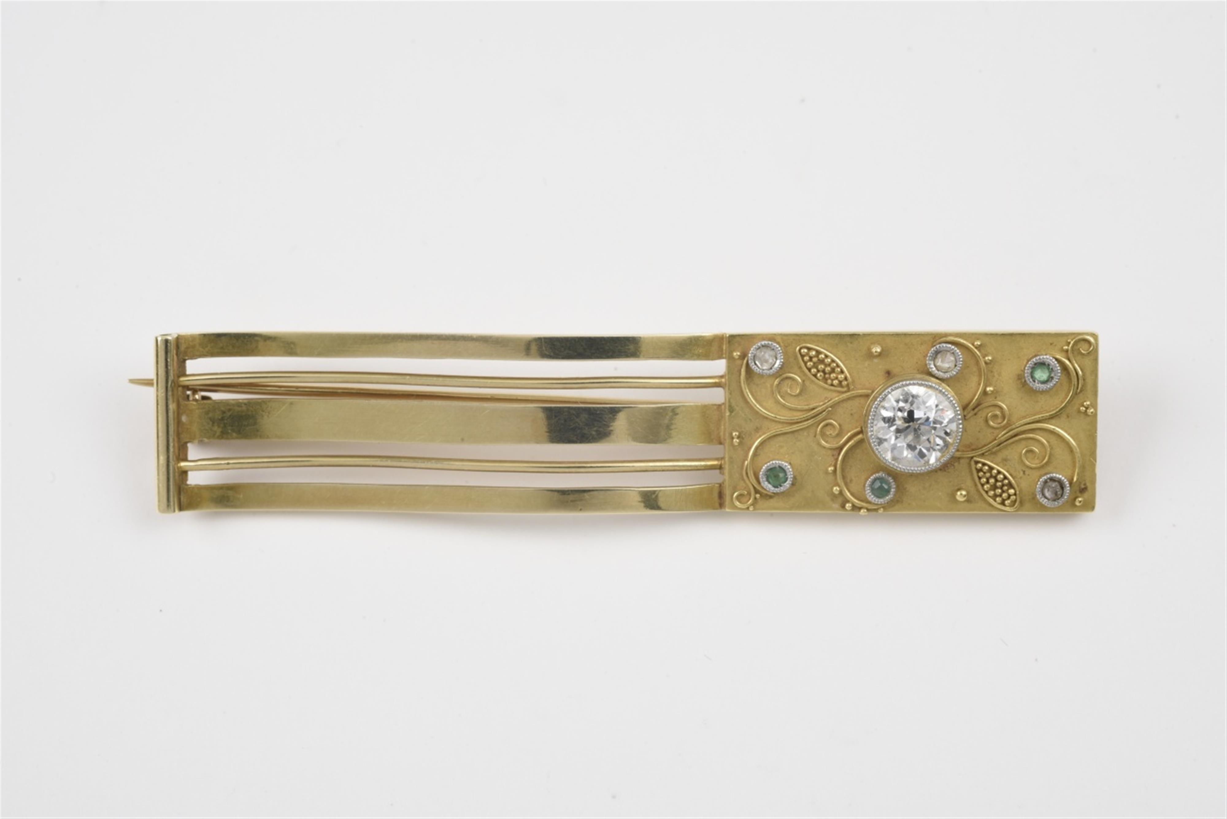 A 14k gold and diamond fibula brooch - image-1