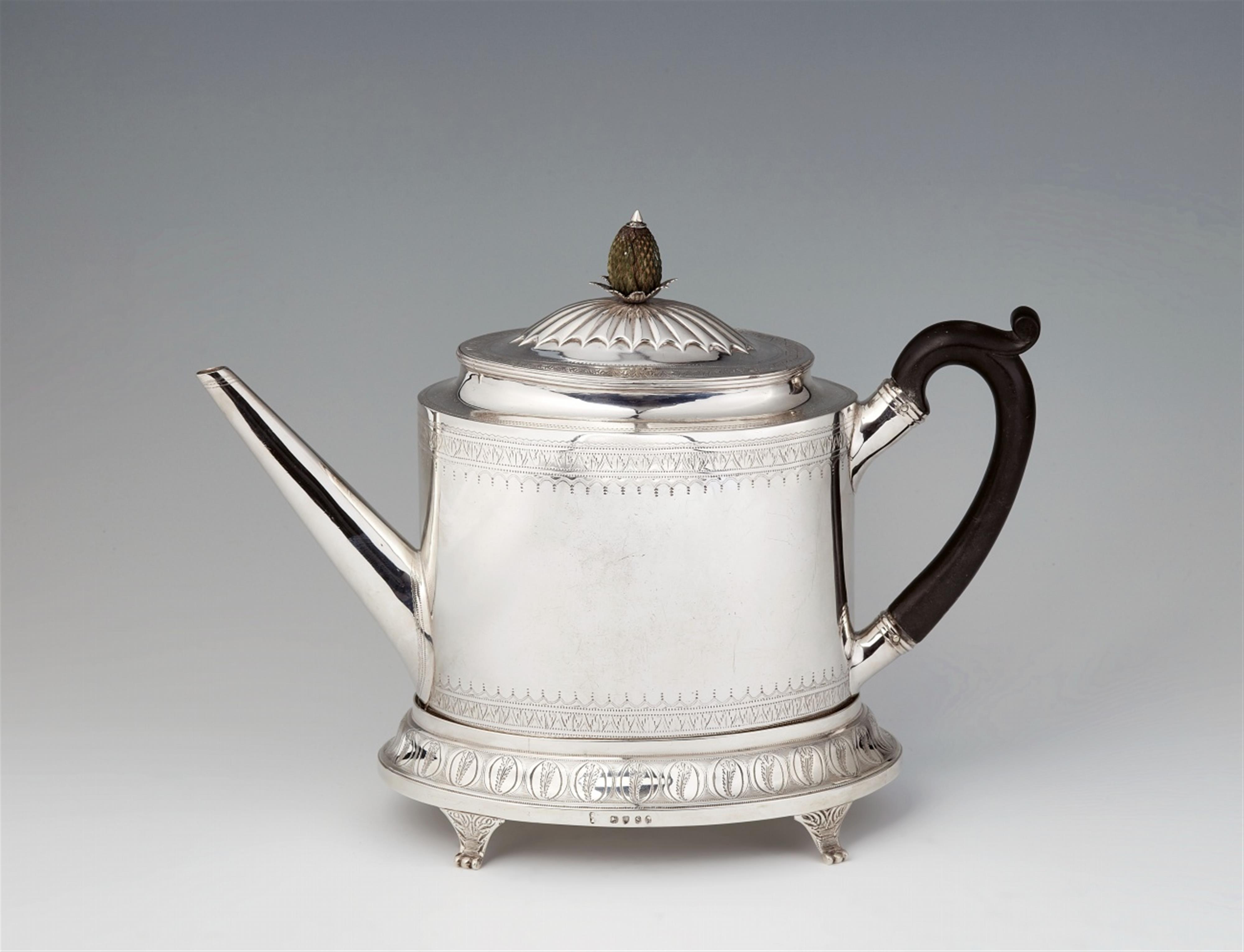 A George III silver teapot and stand - image-1