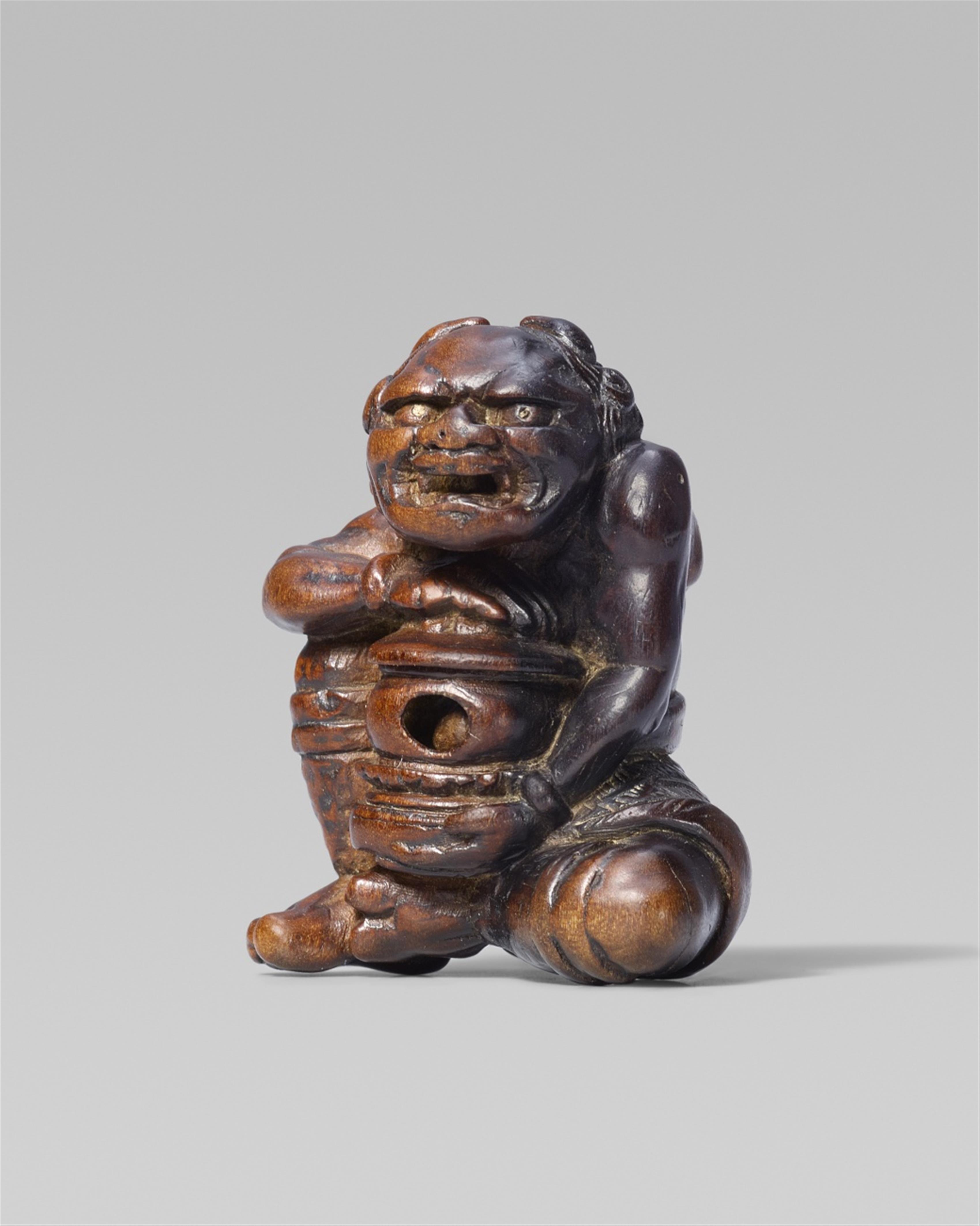 A rare and interesting wood netsuke of an oni with a reliquary, by Awataguchi. First half 19th century - image-1
