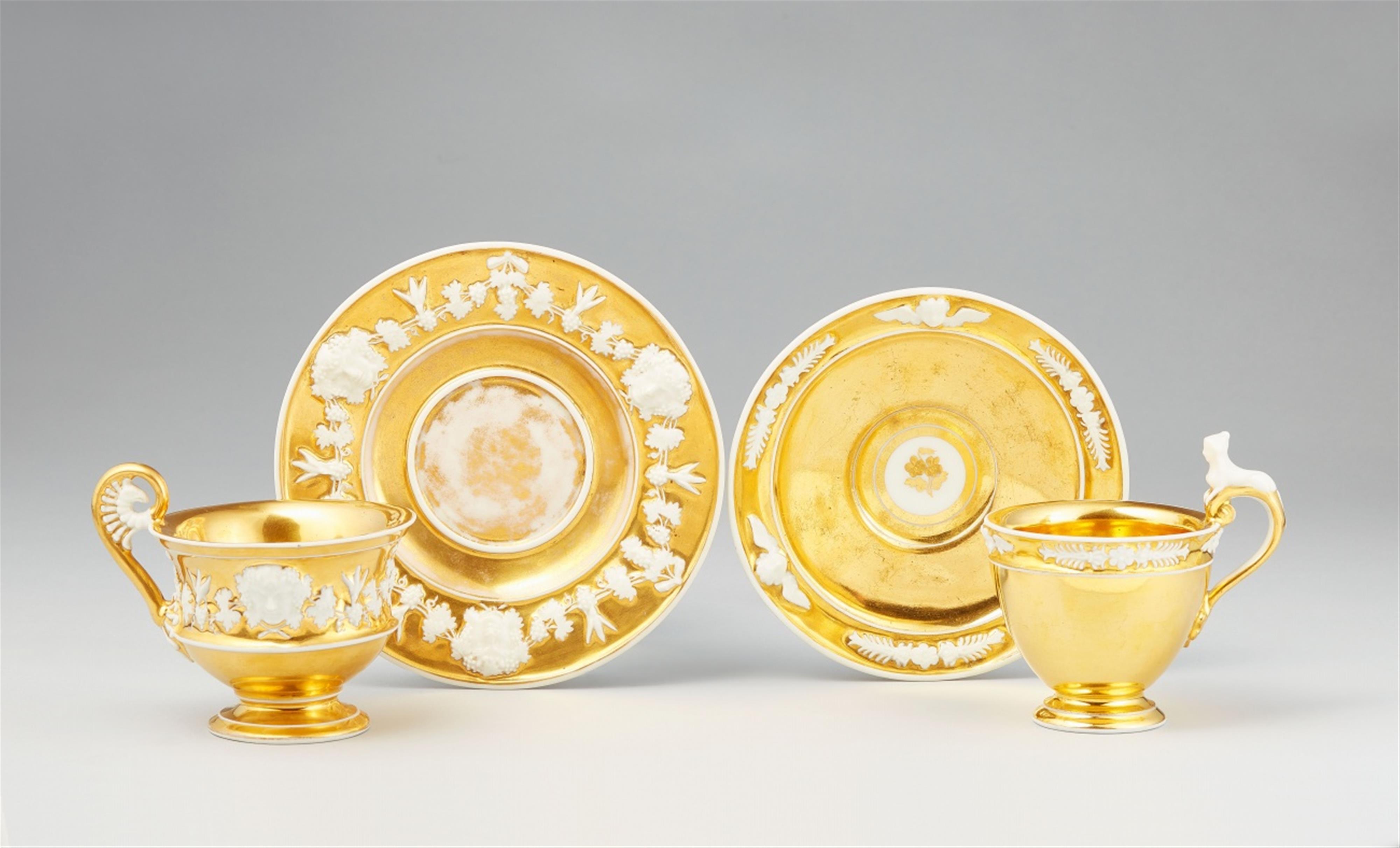 Two Vienna gilt porcelain cups with relief decor - image-1