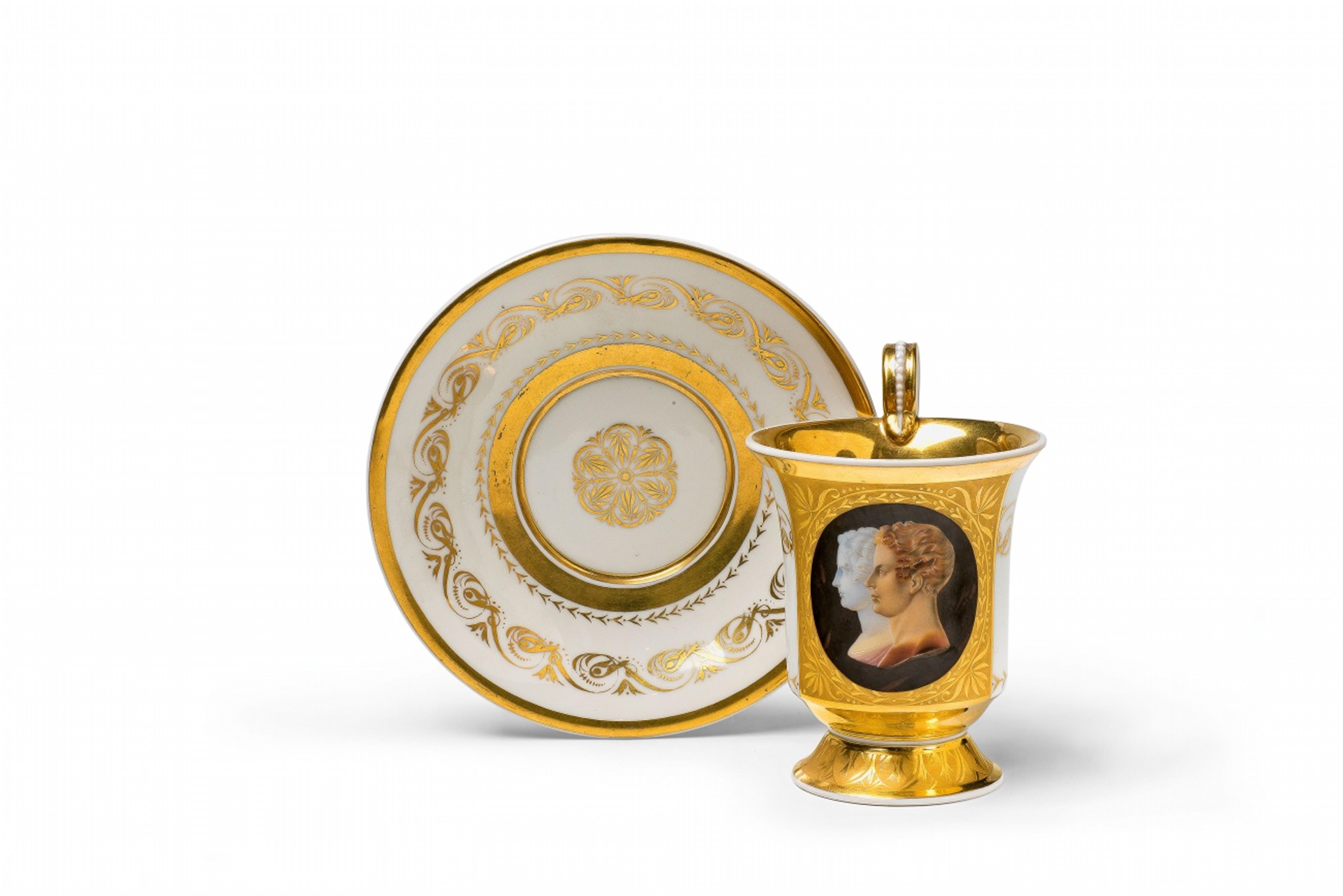 A Berlin KPM porcelain cup and saucer with a faux cameo double-portrait - image-1