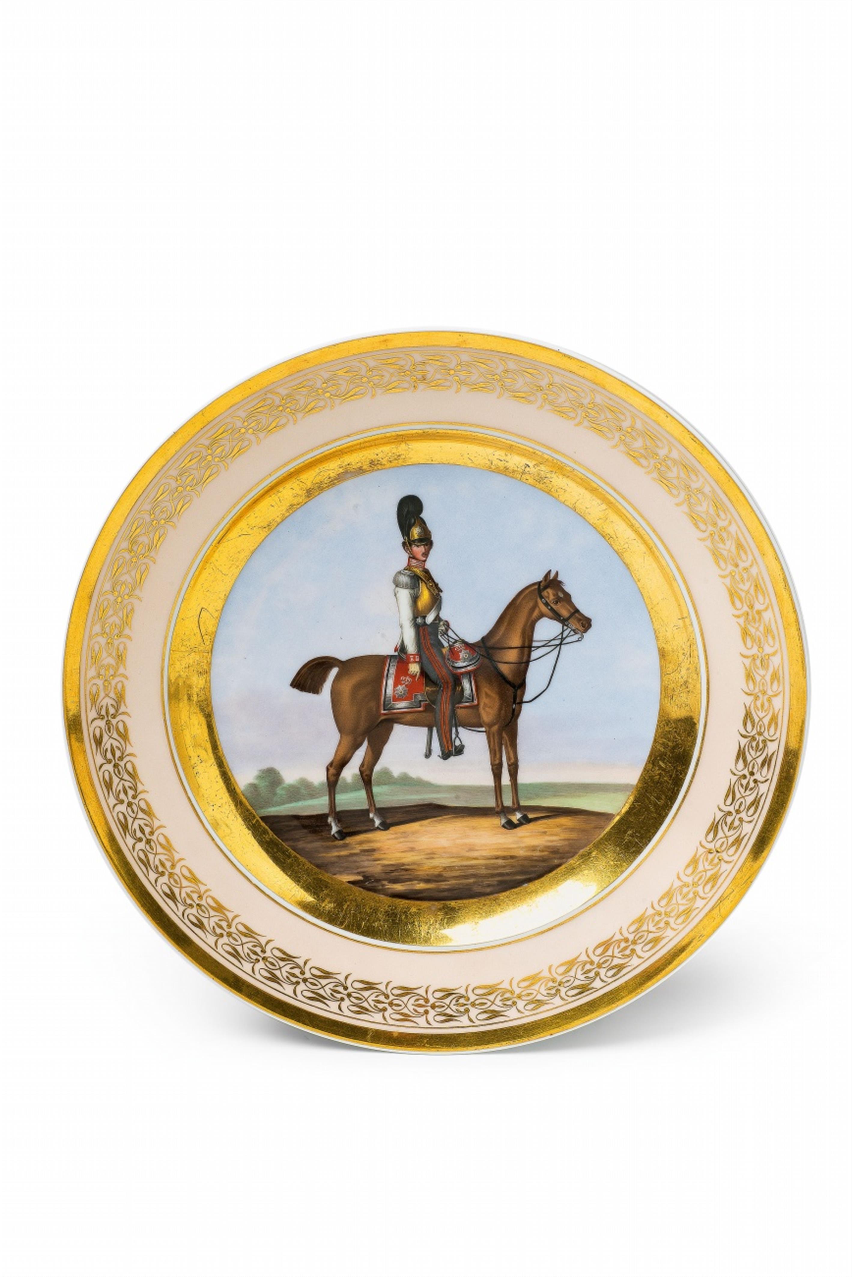 A Berlin KPM porcelain plate with a Prussian cavalryman - image-1