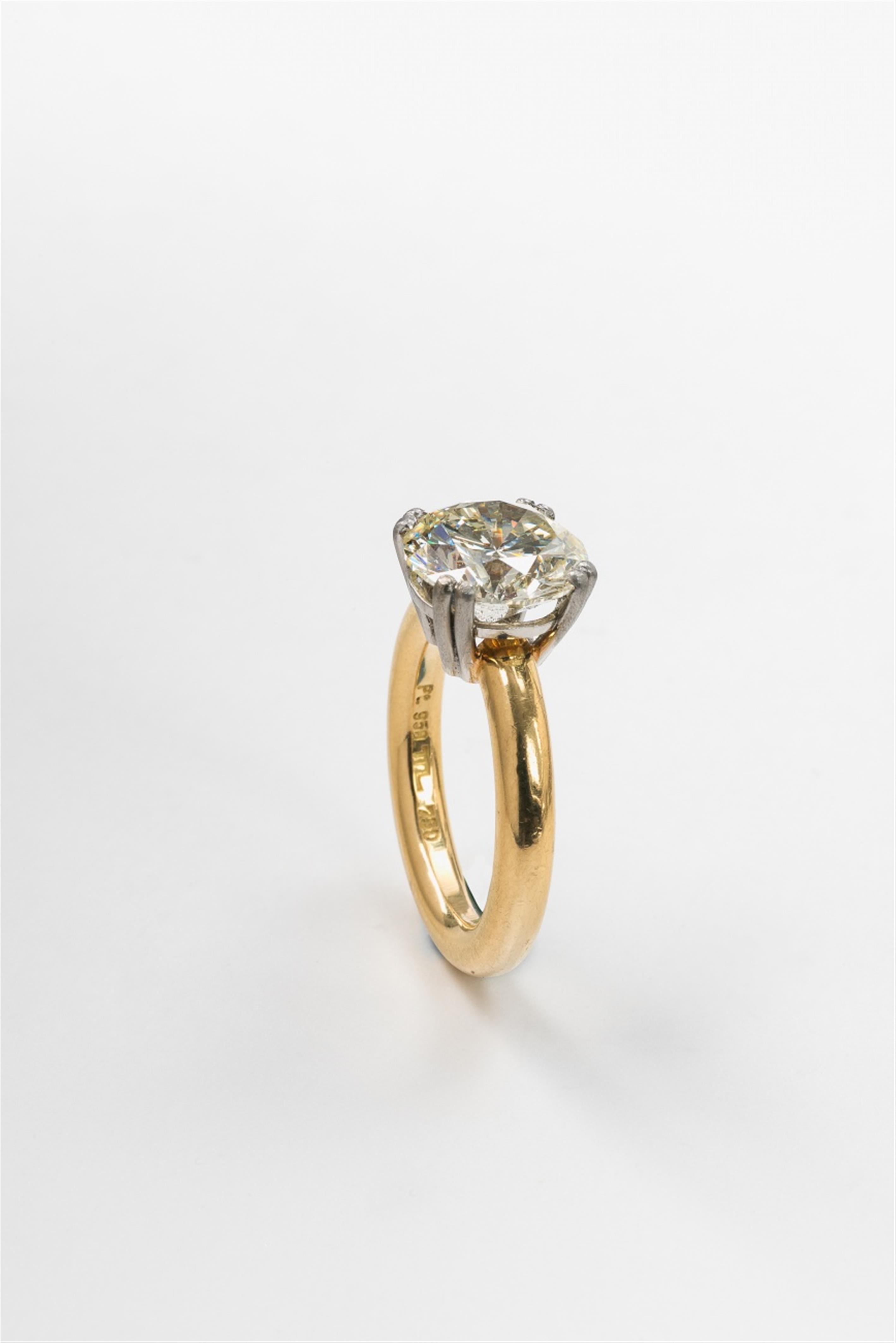 An 18k gold and platinum diamond solitaire ring - image-3