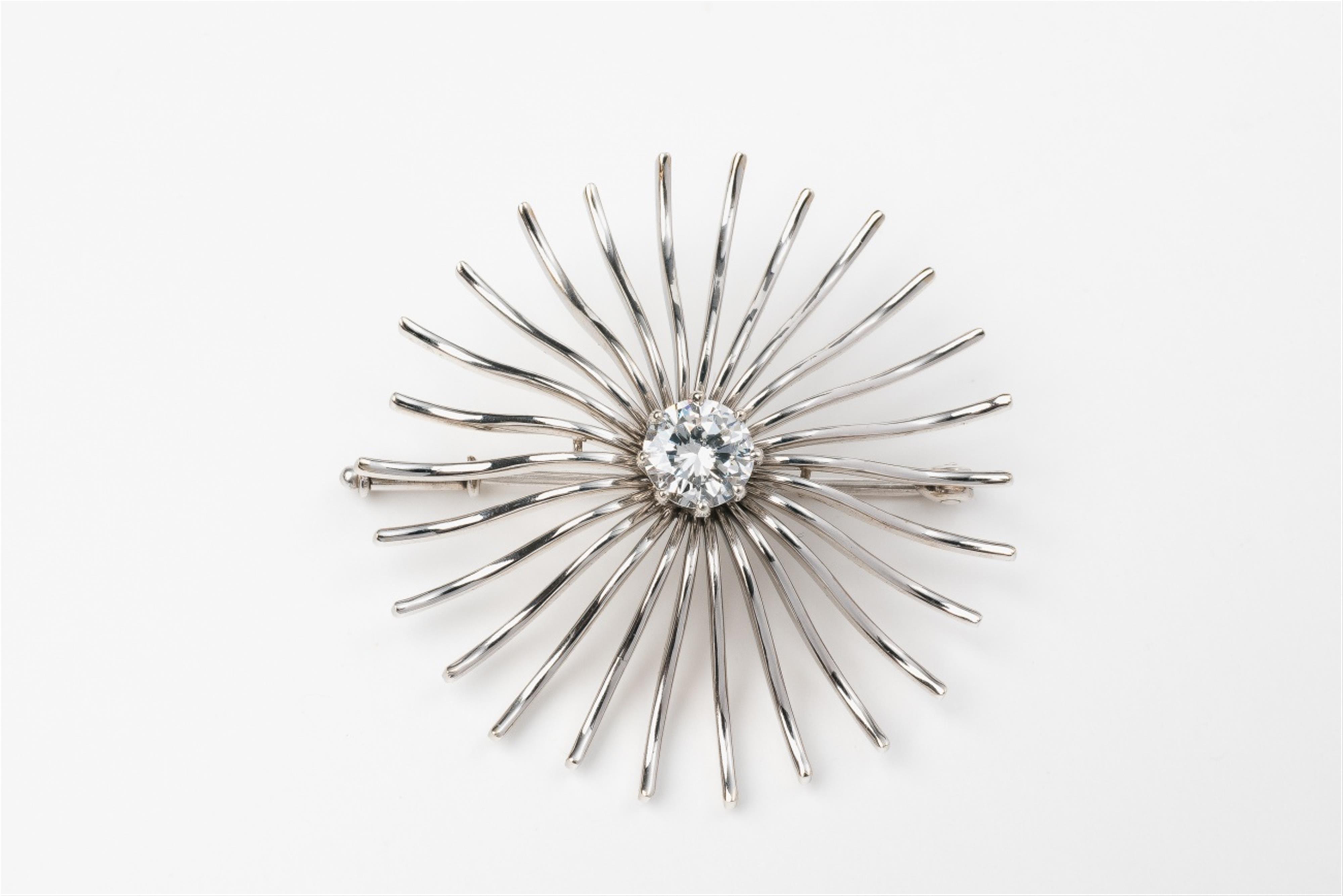 A 14k white gold sun brooch with a diamond solitaire - image-1