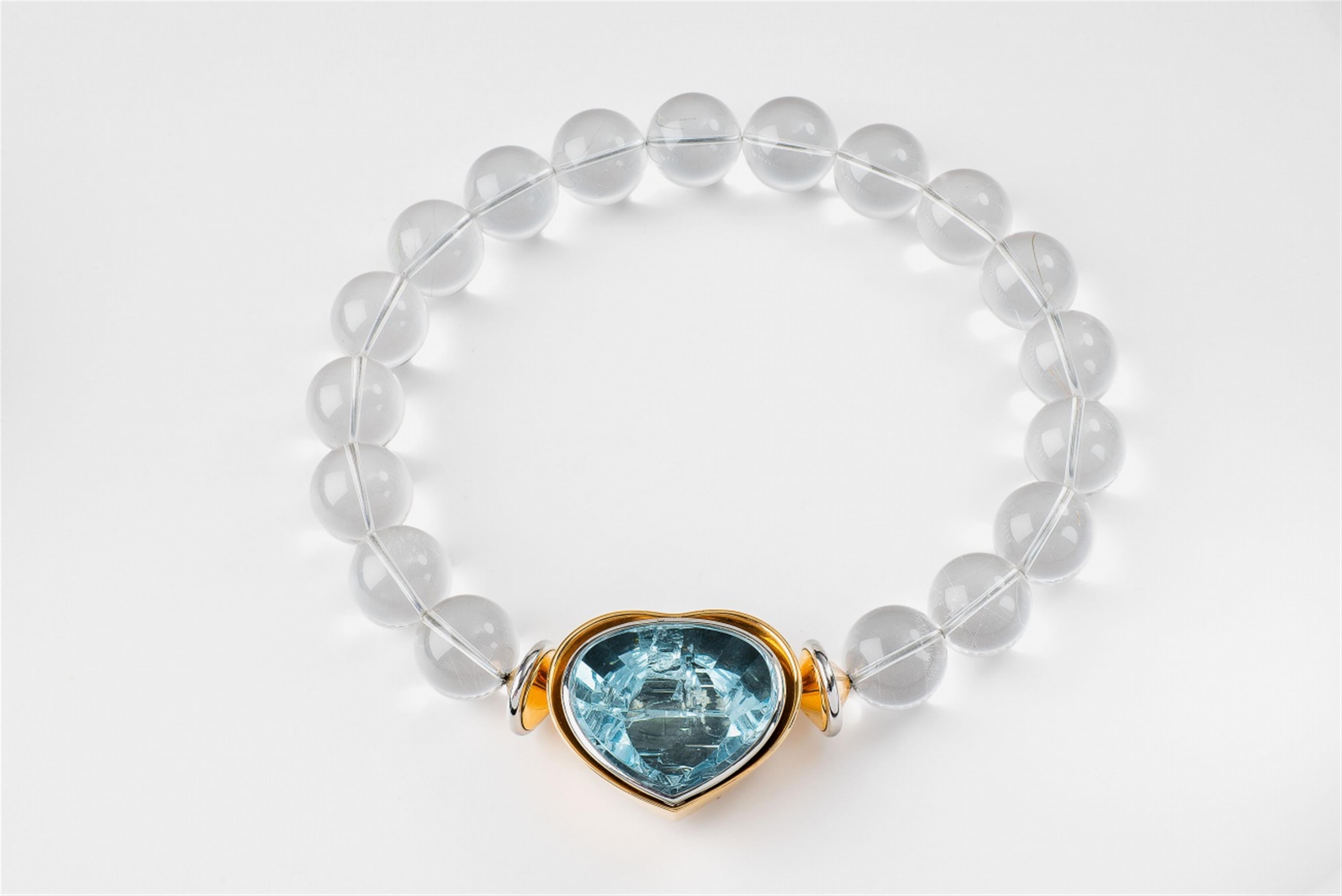 An 18k gold platinum and rock crystal necklace with an aquamarine heart - image-2