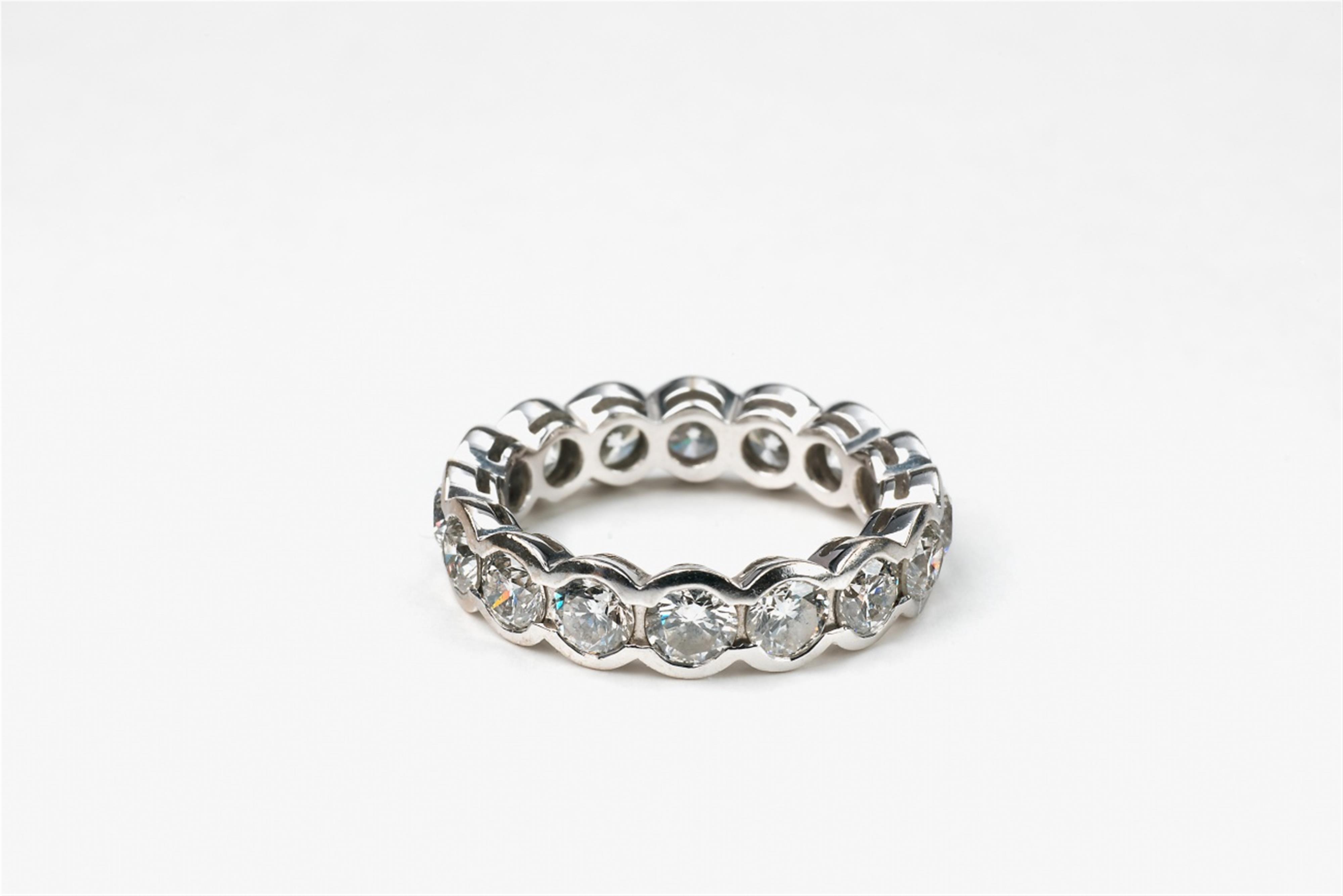 An 18k white gold and diamond eternity ring - image-2
