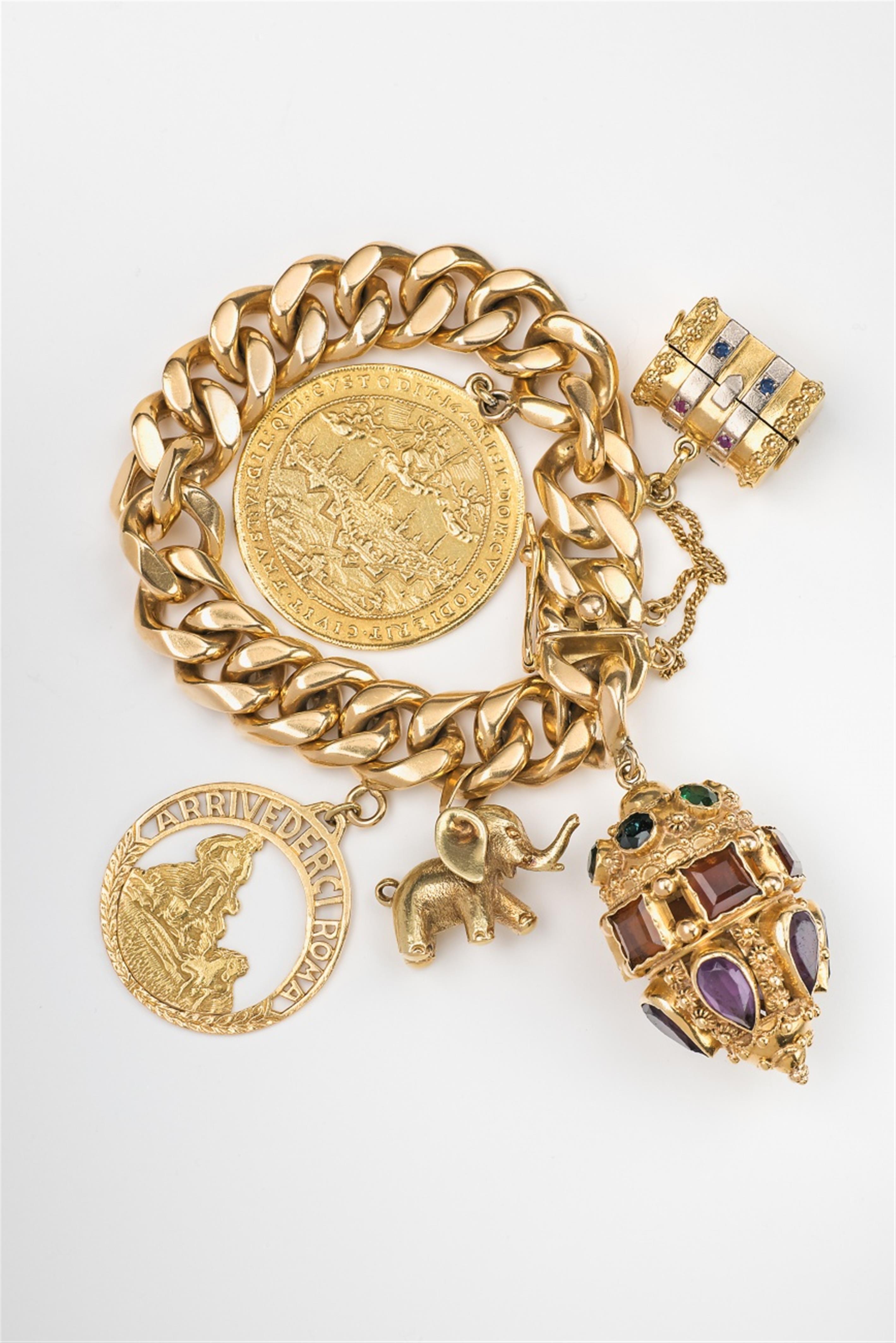 An 18k gold bracelet with souvenir charms - image-1
