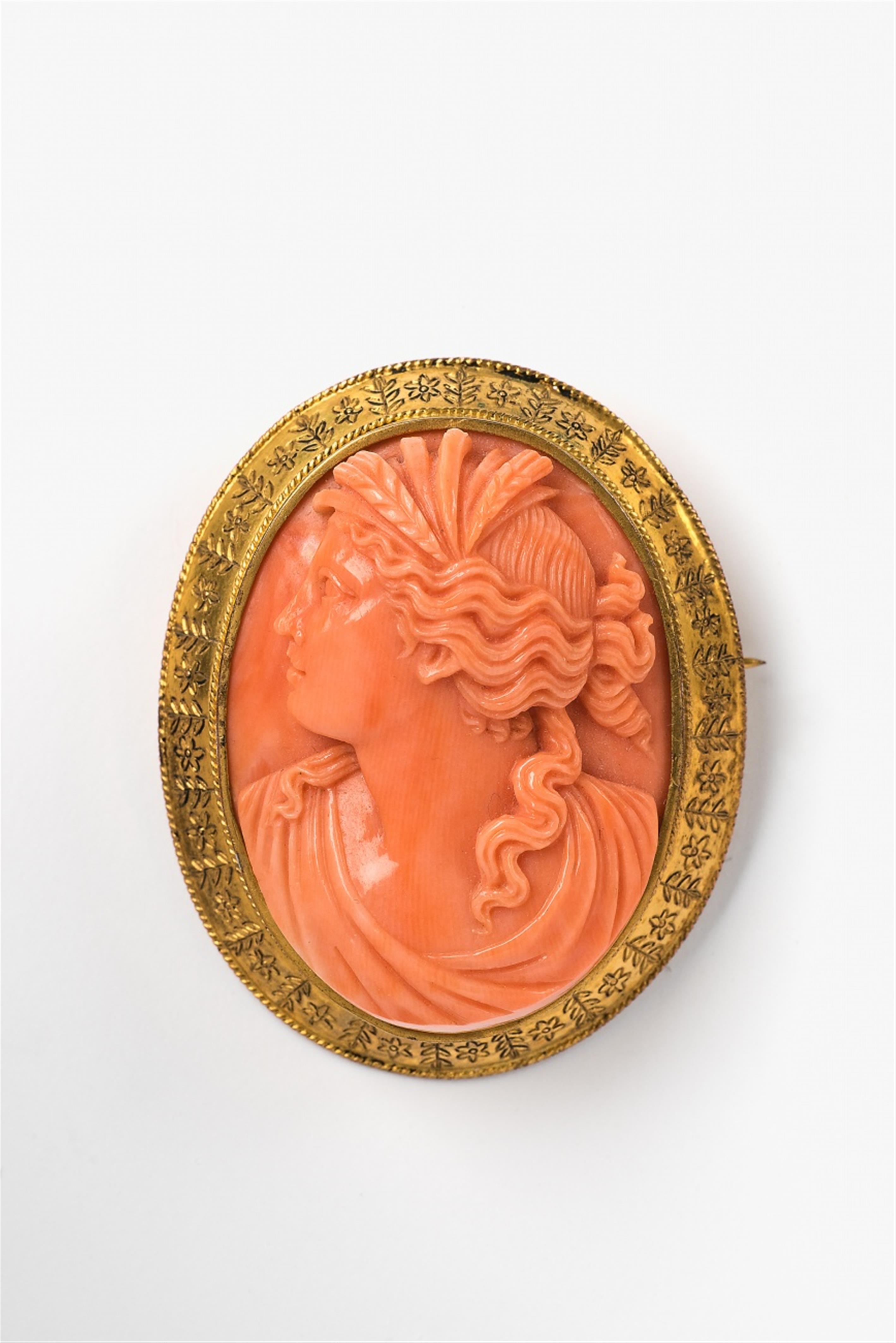 A French gilt metal and coral cameo brooch - image-1