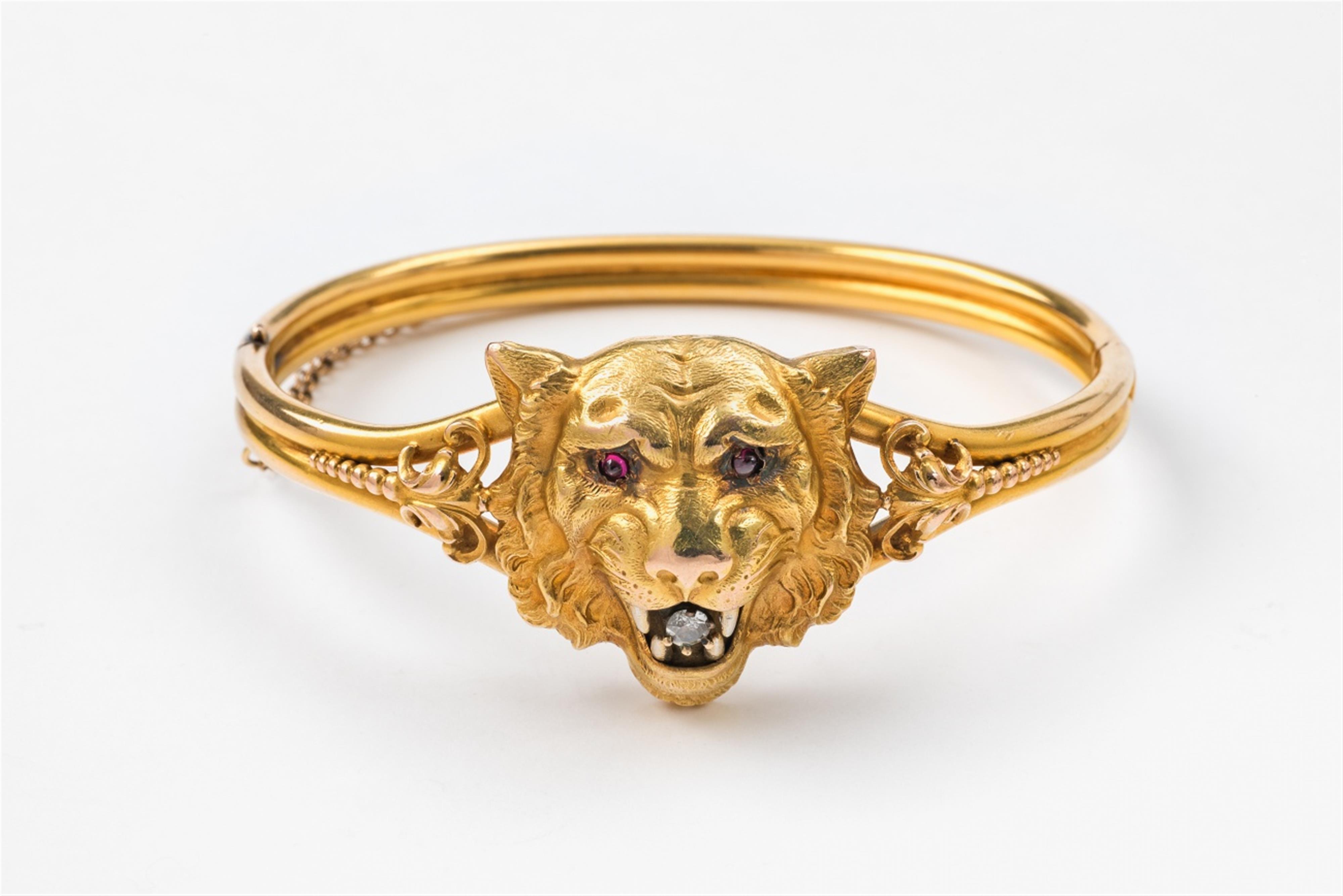An American 14k gold diamond and ruby lion bangle - image-1