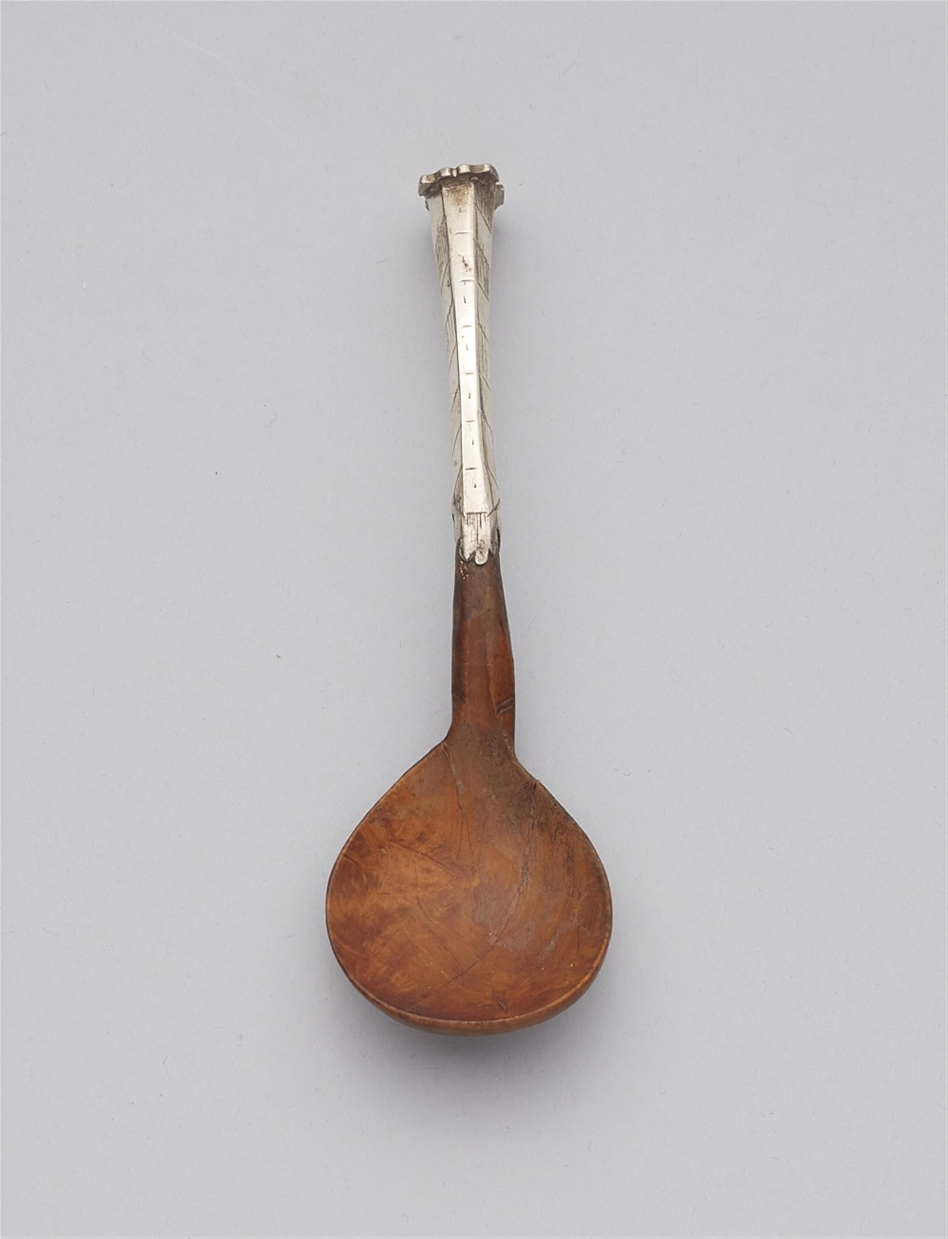 A silver and rootwood spoon - image-1