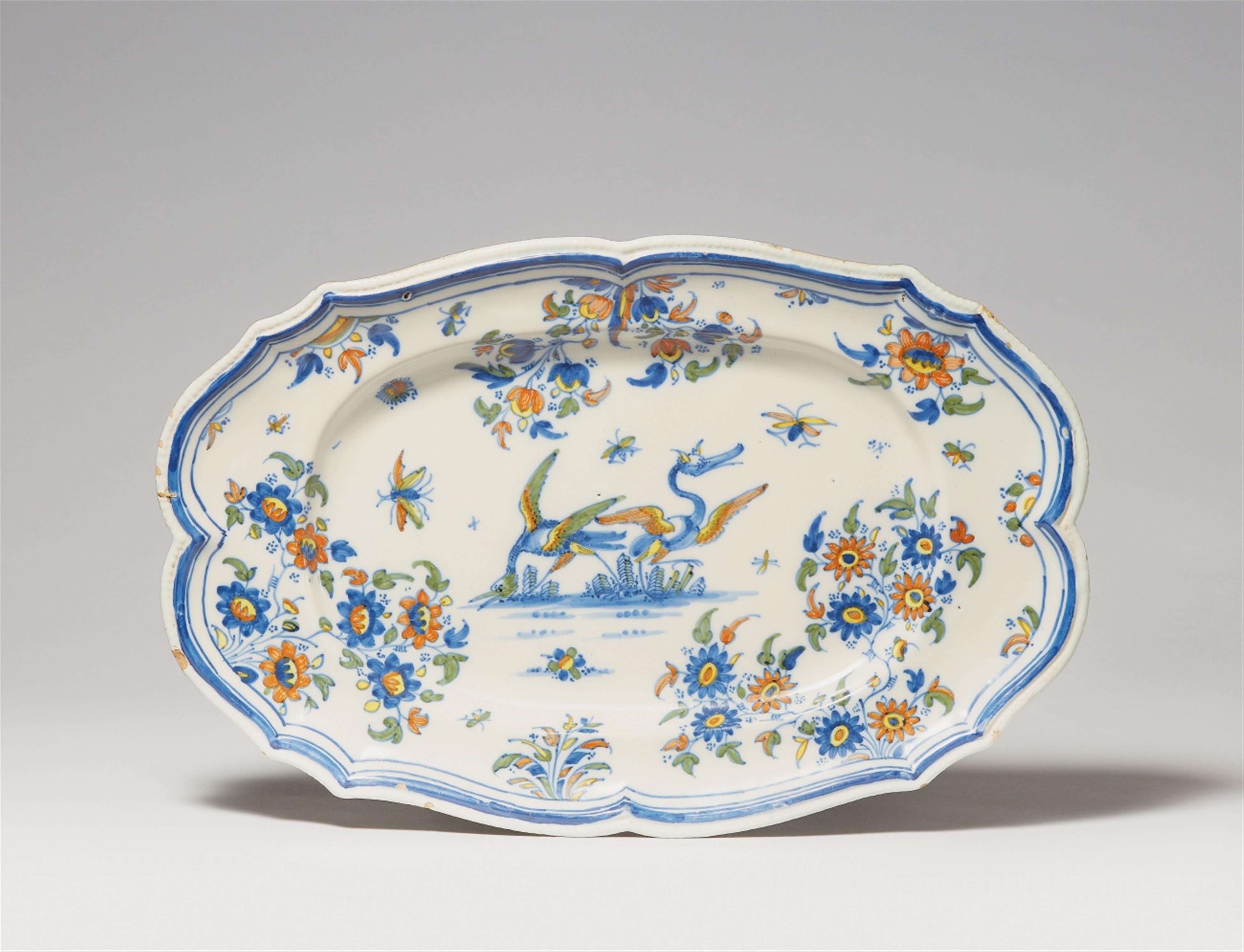 An oval Alcora faience platter with a bird and insects - image-1