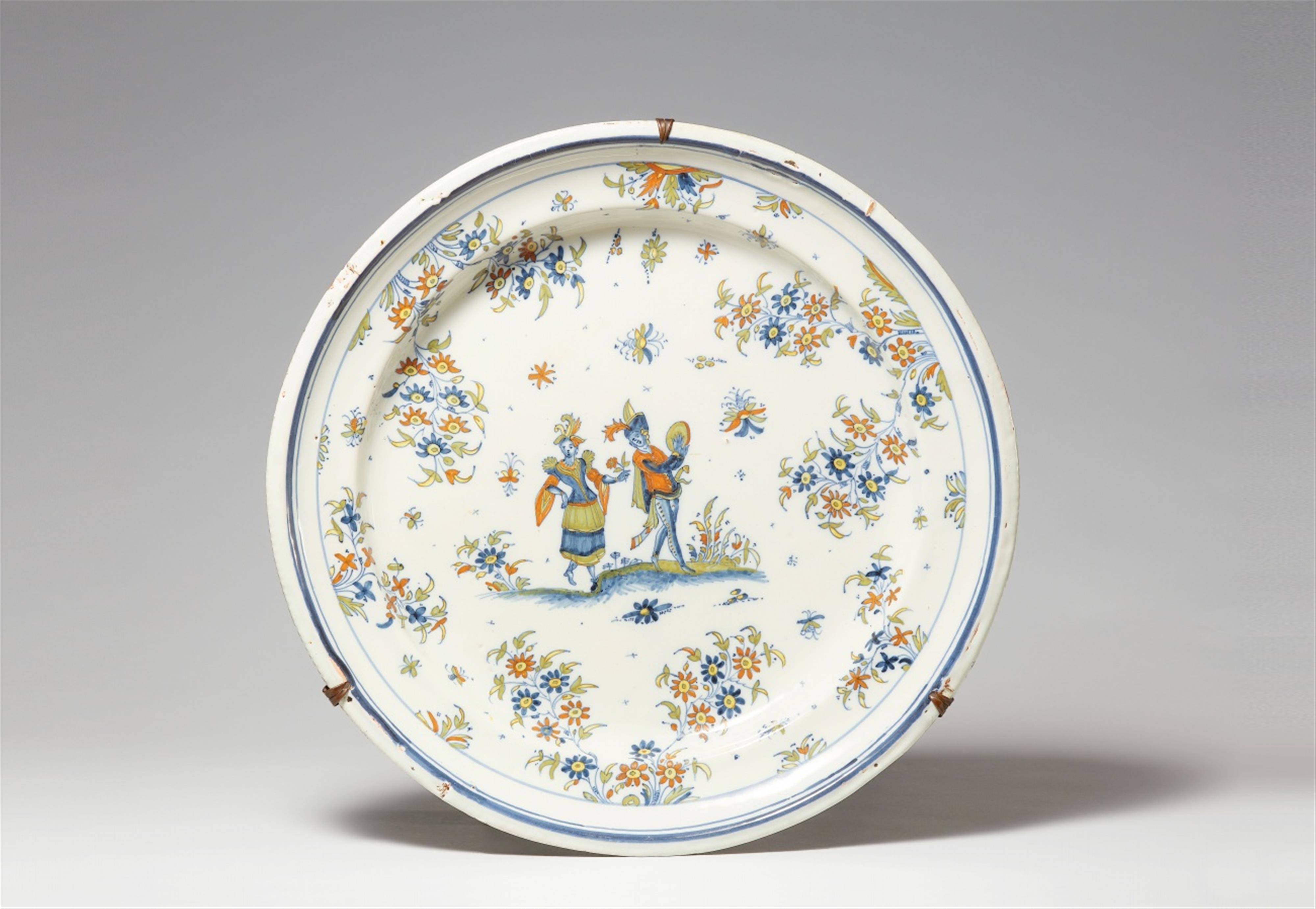 An Alcora faience platter with a dancing couple - image-1