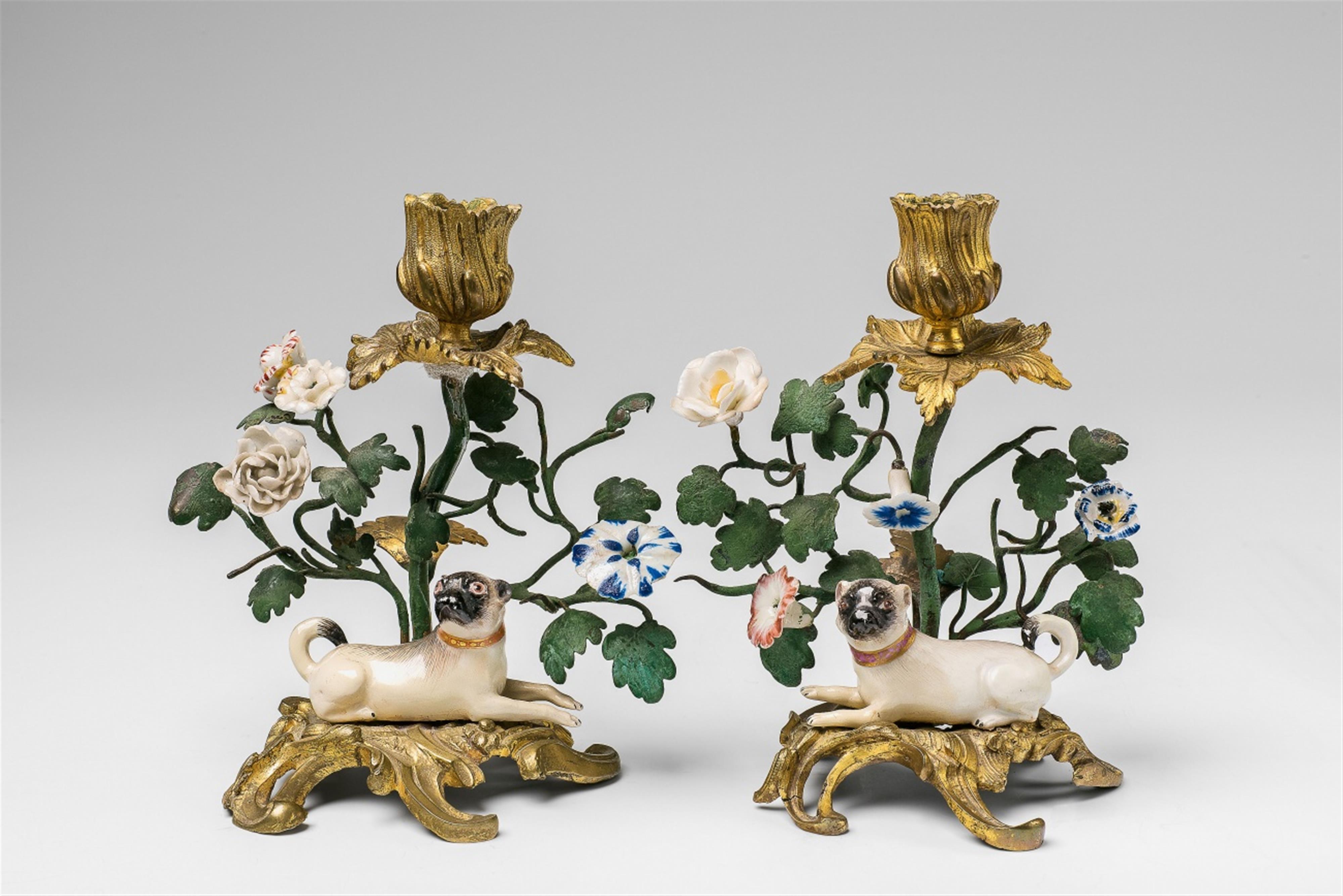 A pair of ormolu candle sticks with Meissen porcelain pug dogs - image-1