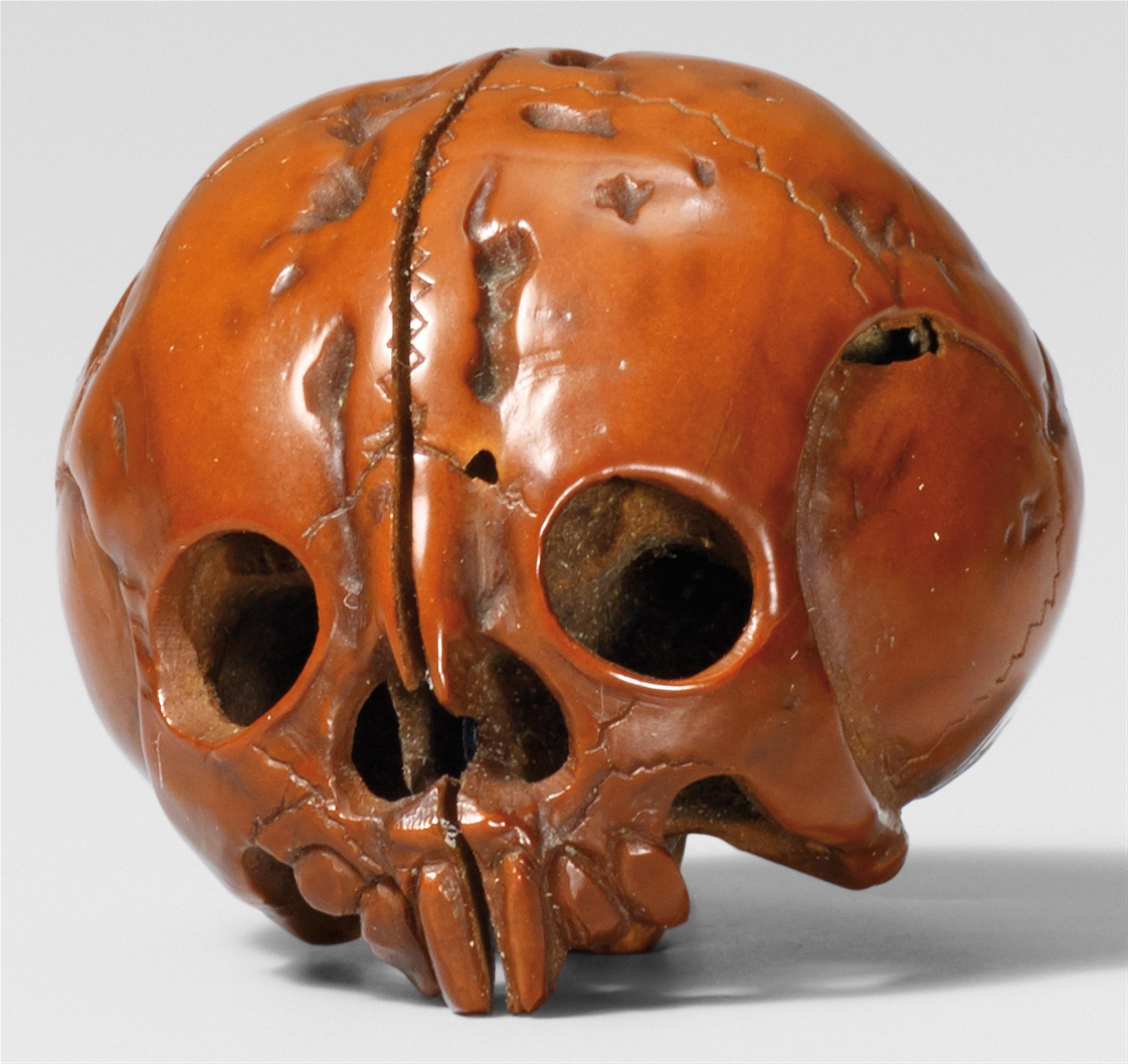 A walnut netsuke of a skull. 19th century - image-1