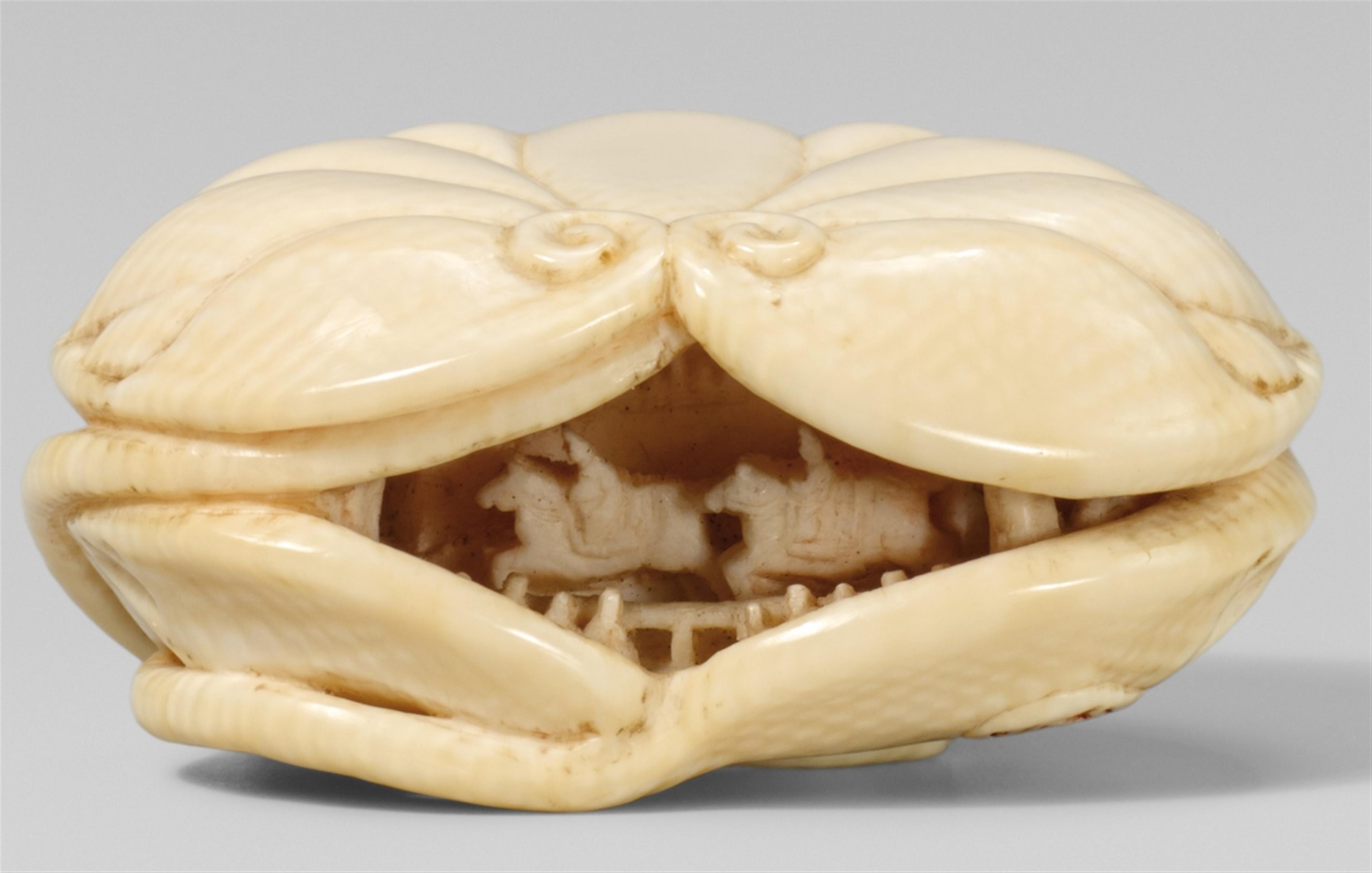 An ivory netsuke of a miniature carving between two aoi-leaves. Late 19th century - image-1