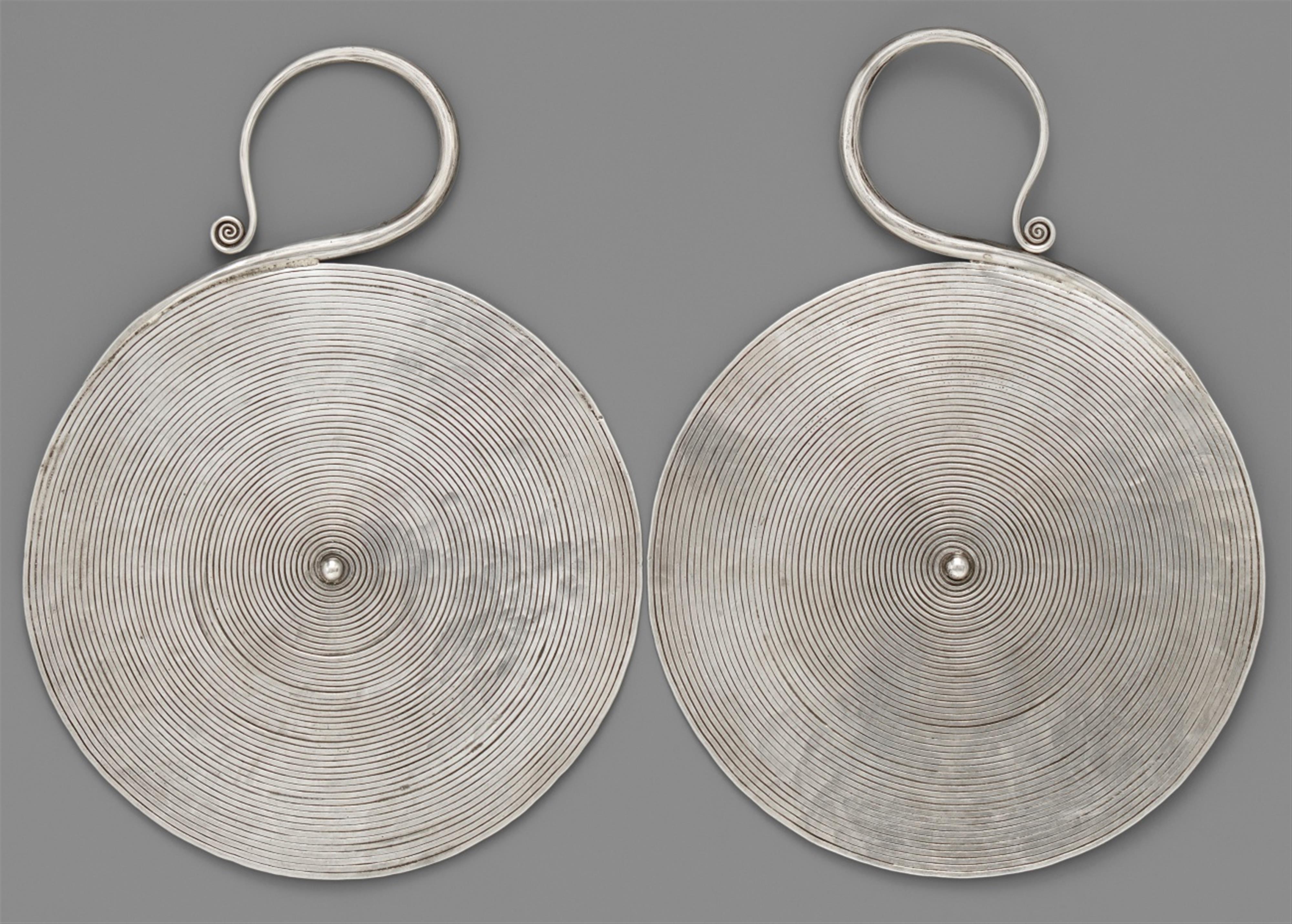 A pair of very large silver earrings of the Miao tribe. Southern China, Guizhou province, Huishui district, Baijin village. Ca. 1960 - image-1