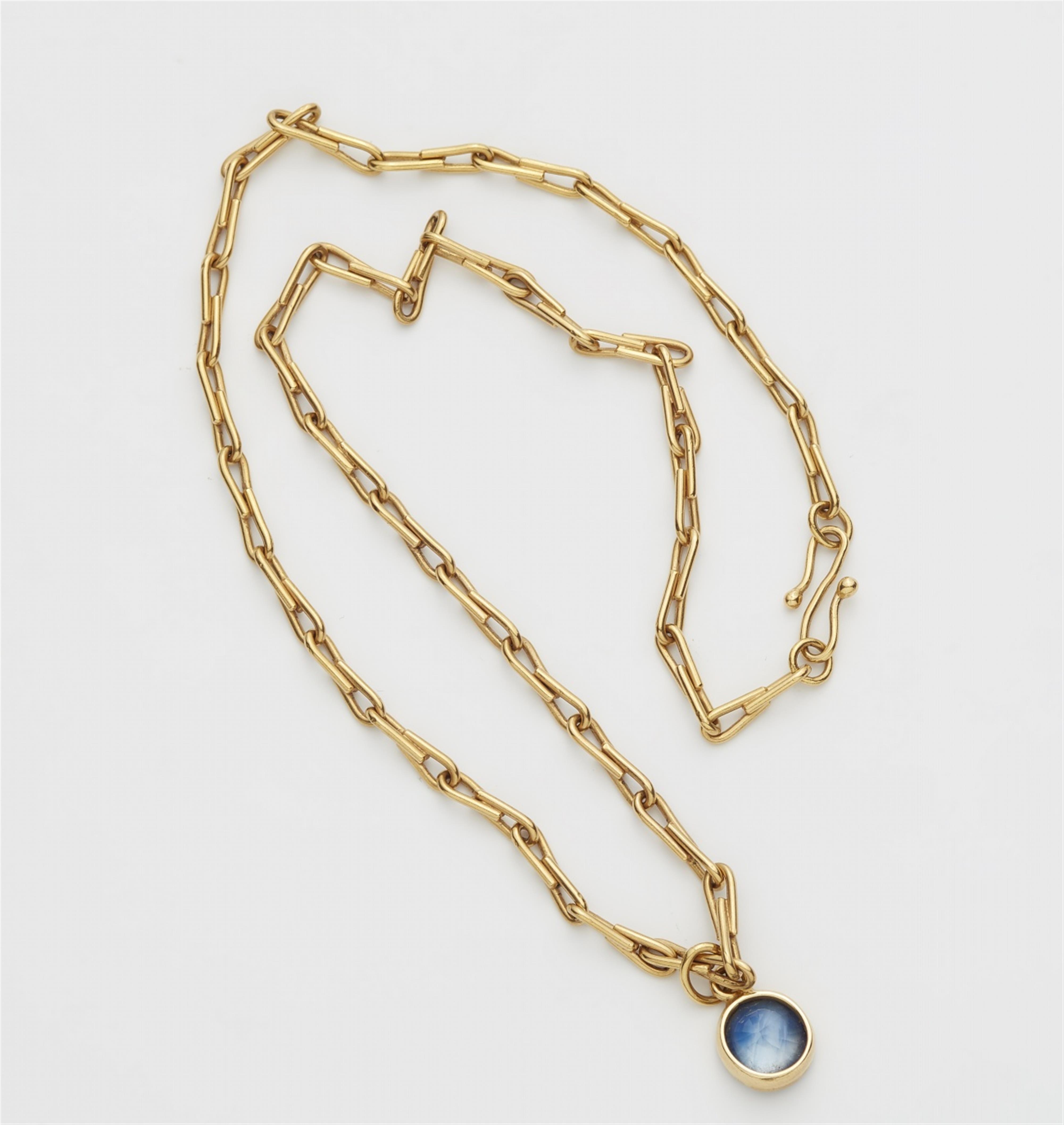 An 18k gold and sapphire pendant - image-2