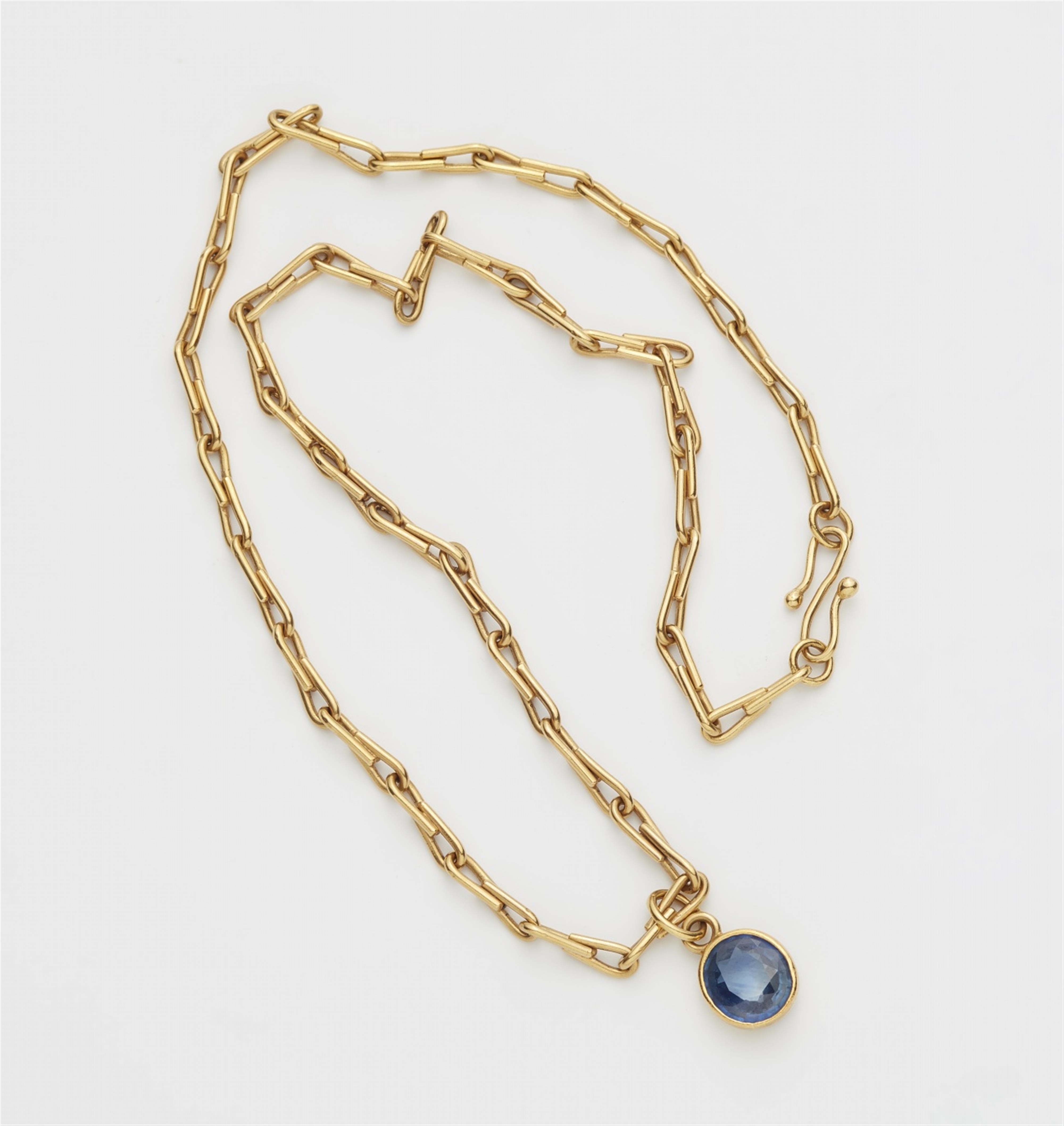 An 18k gold and sapphire pendant - image-1