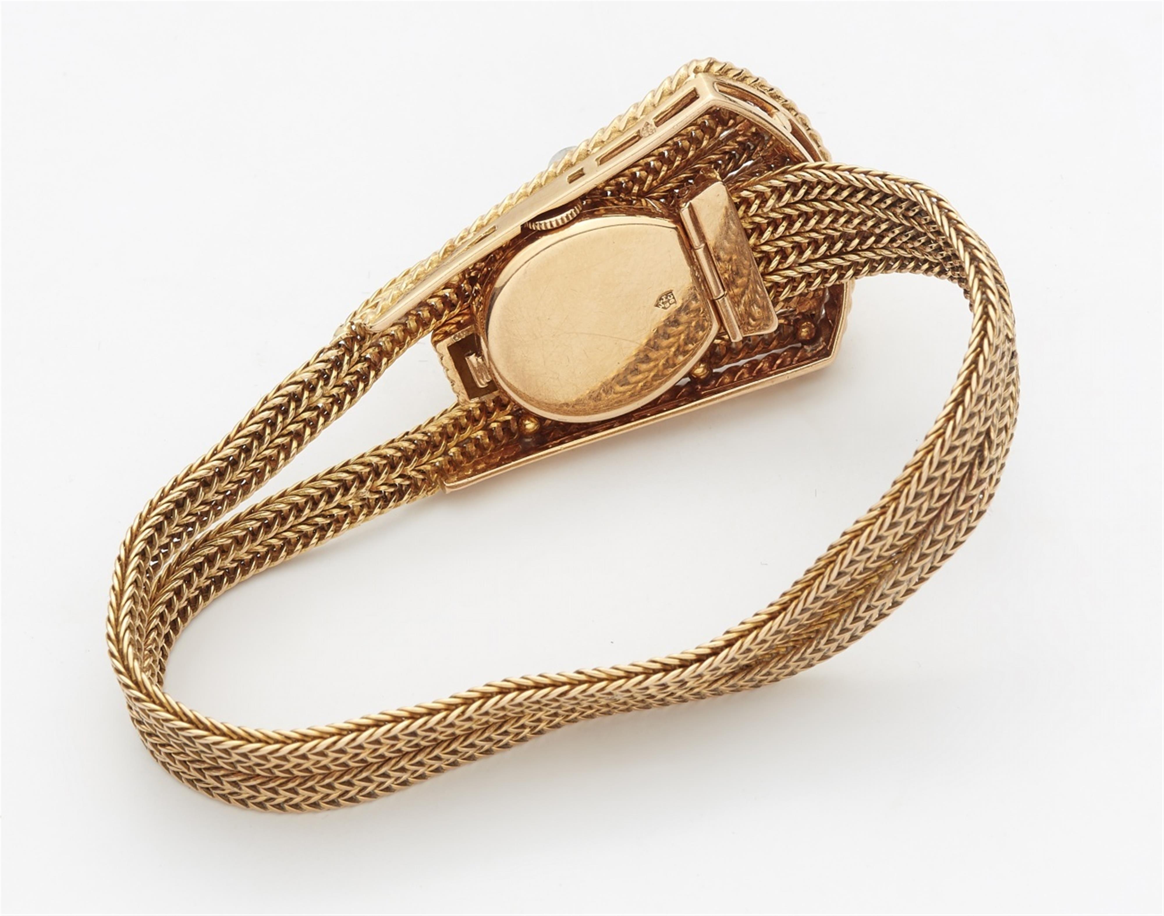 An 18k gold cuff bracelet with a watch - image-2