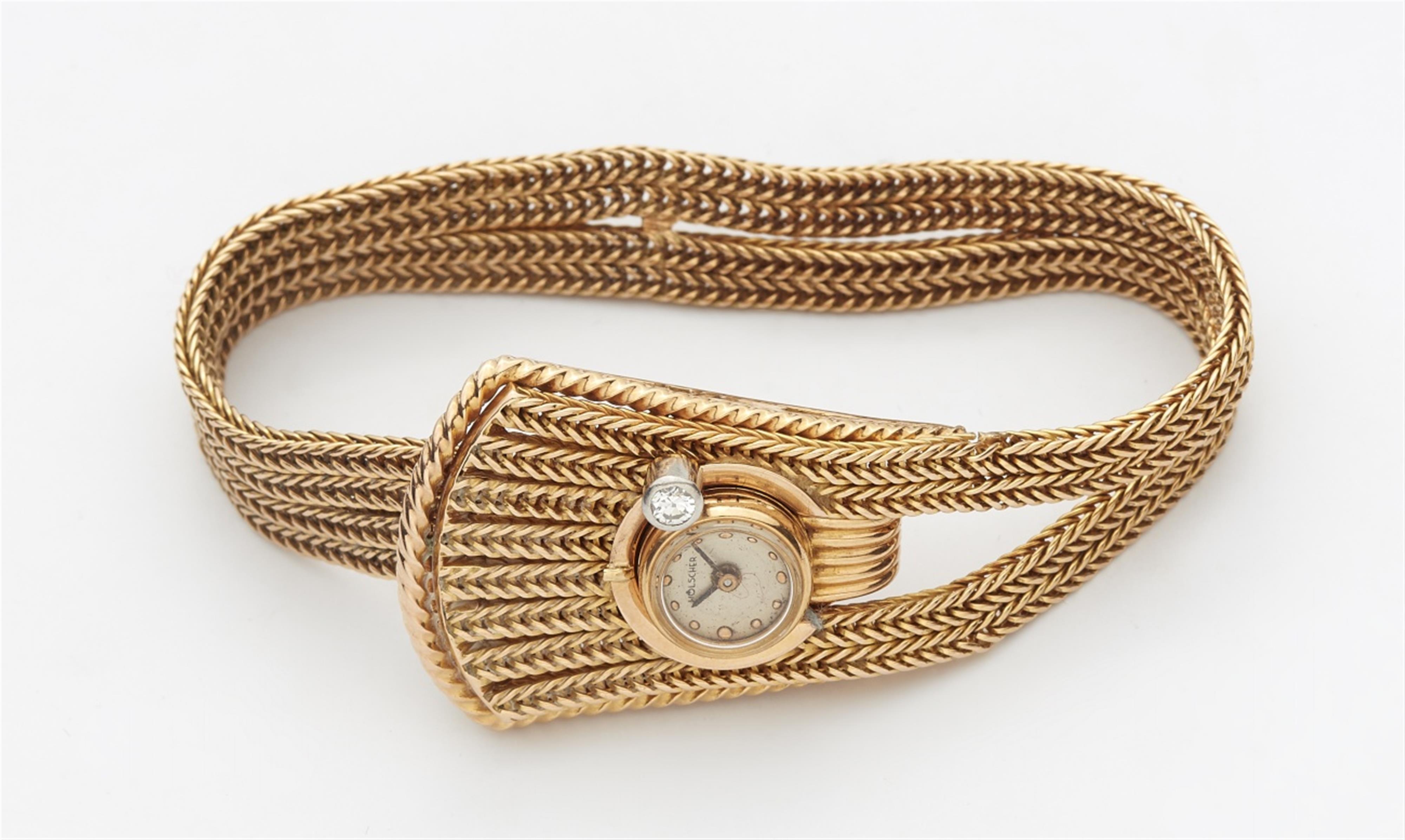 An 18k gold cuff bracelet with a watch - image-1