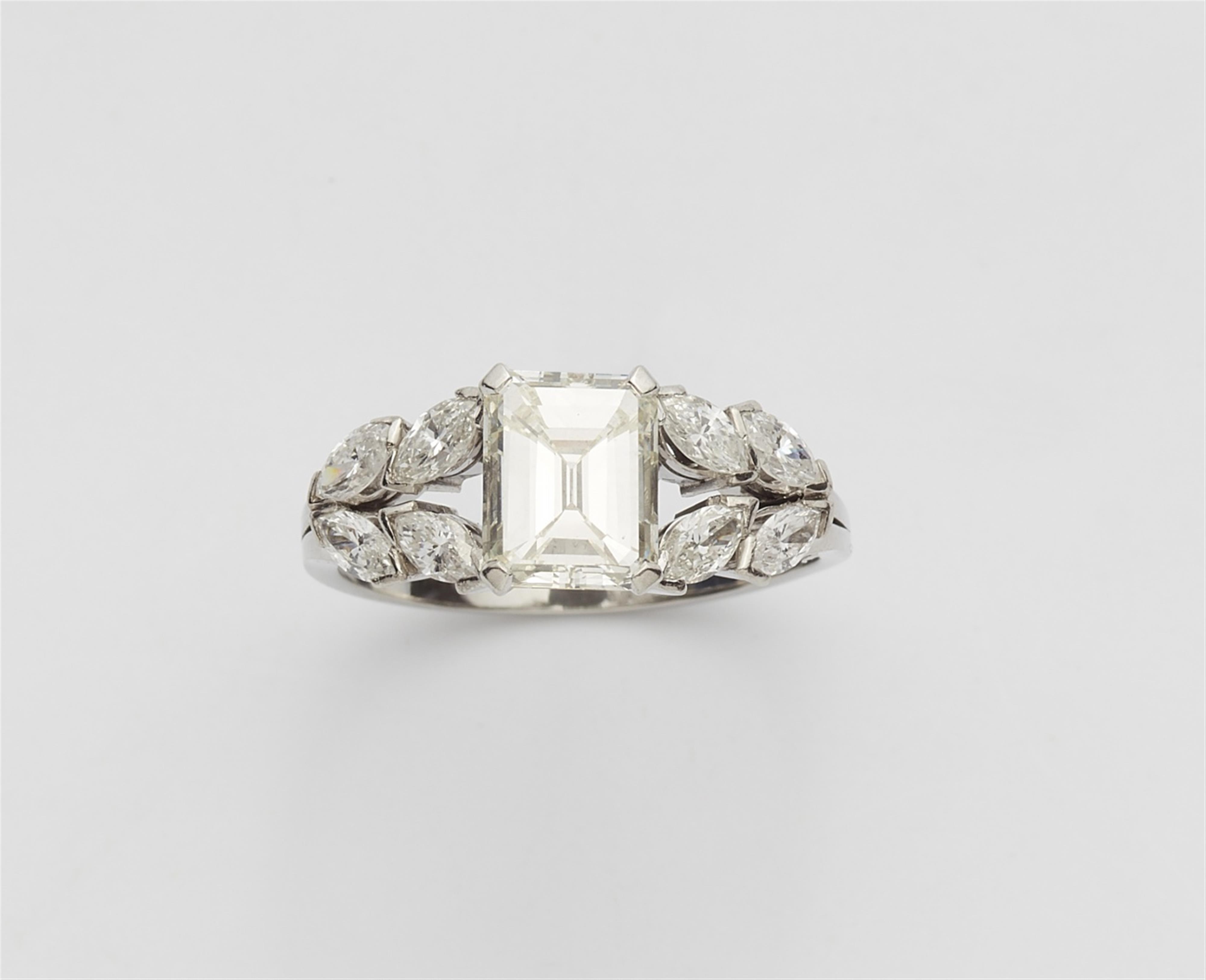 A platinum ring with an emerald-cut diamond - image-1