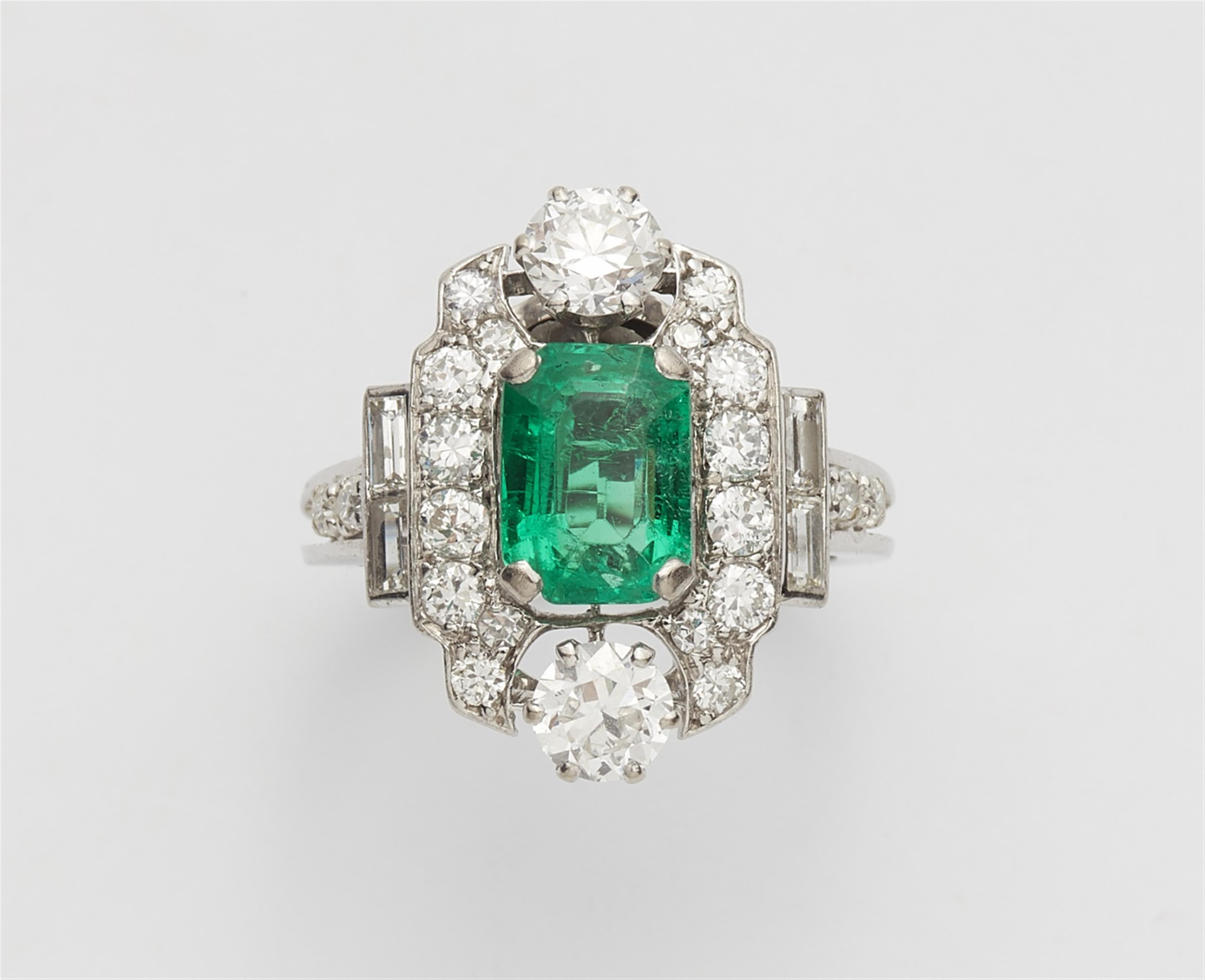 An 18k white gold, diamond, and emerald ring - image-1