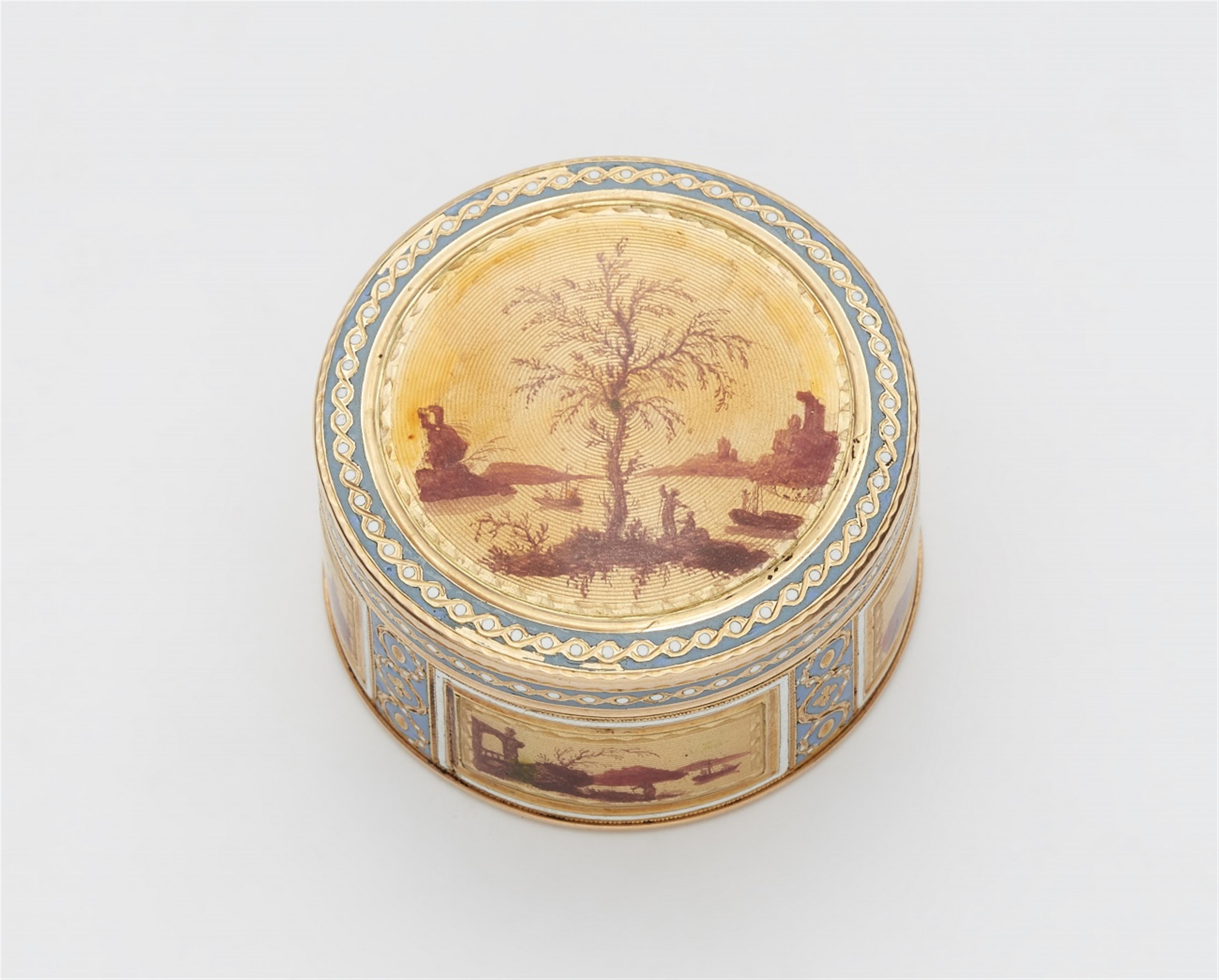 A small round enamelled gold snuff box - image-1