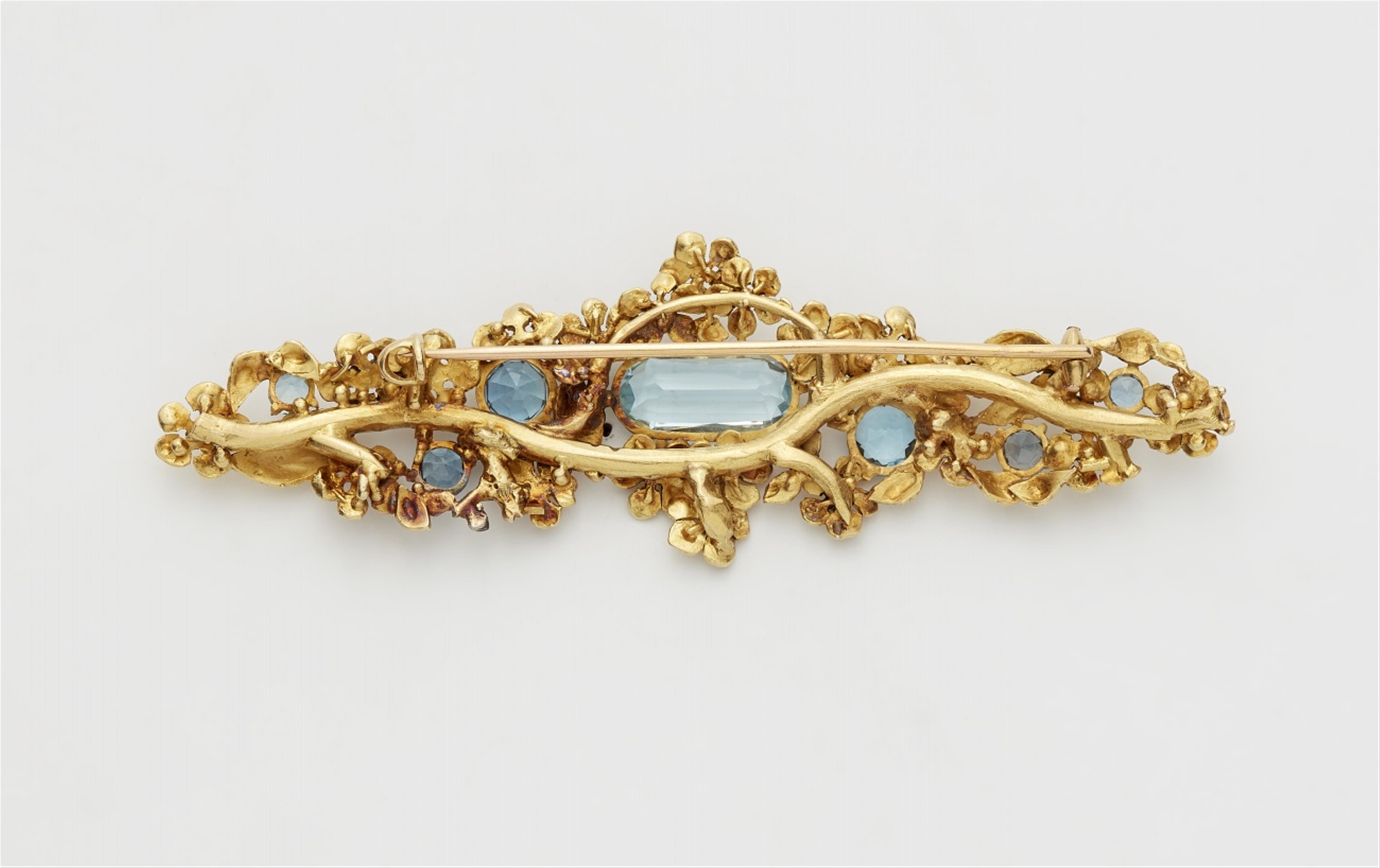 An 18k gold floral brooch with blue topaz - image-2