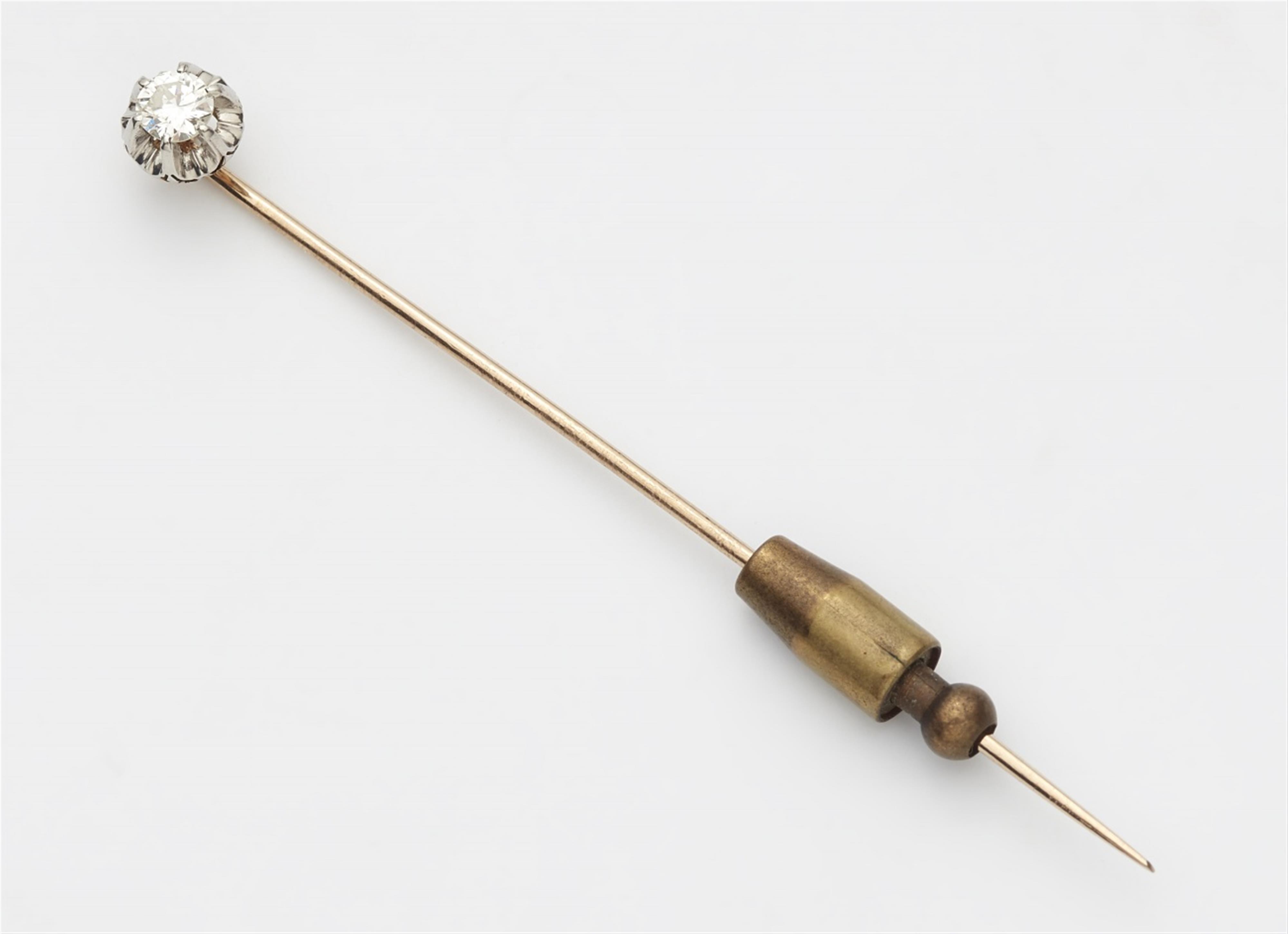 An 18k gold tie pin with a diamond solitaire - image-1